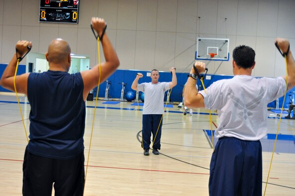 U.S. Air Force Staff Sgt. Daniel Bedford leads an arm-strengthening exercise during a four-day Cooper Institute Military Exercise Leader course at March Air Reserve Base, Calif., May 10, 2011.  The course is part of an ongoing effort to create a culture of fitness at the base.  (U.S. Air Force photo/ Megan Just)