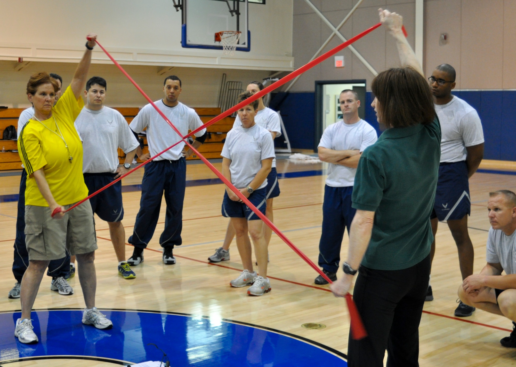 Cooper Institute instructors (left) Karyn Hughes, M.Ed. and (right) Sue Beckham, Ph.D. demonstrate an arm strengthening partners exercise during the four-day Military Exercise Leader course at March Air Reserve Base, Calif., May 10, 2011.  The course is part of an ongoing effort to create a culture of fitness at the base.  (U.S. Air Force photo/ Megan Just)