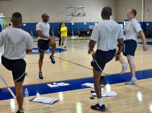 U.S. Air Force Staff Sgt. Antwan Gabriel leads a warm-up exercise during a four-day Cooper Institute Military Exercise Leader course at March Air Reserve Base, Calif., May 10, 2011.  The course is part of an ongoing effort to create a culture of fitness at the base.  (U.S. Air Force photo/ Megan Just)