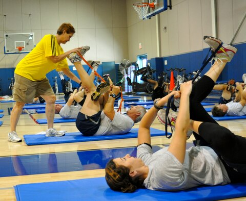 Staff Sgt. Jen Theurer, California Air National Guard 163rd Civil Engineering Squadron, watches Cooper Institute instructor Karyn Hughes, M.Ed. help Senior Master Sgt. Michael Kacsmaryk, 452nd Maintenance Operations Squadron, with his stretching technique during the four-day Military Exercise Leader course at March Air Reserve Base, Calif., May 10, 2011.  The course is part of an ongoing effort to create a culture of fitness at the base.  (U.S. Air Force photo/ Megan Just)
