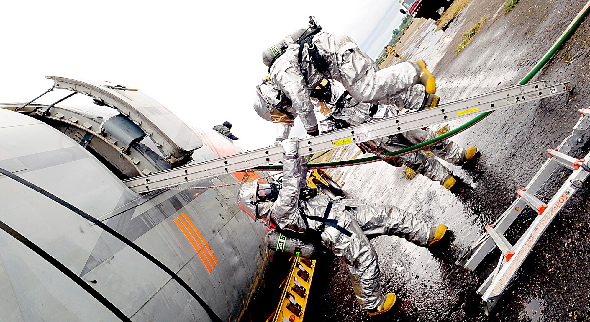 RAF HONINGTON, England -- RAF Mildenhall firefighters work together to move in and out of mock plane wreckage safely during a major accident response exercise held at RAF Honington May 18, 2011. The MARE was held to give the U.S. Air Forces in Europe Inspector General Team the chance to test the 100th Air Refueling Wing's Exercise Evaluation Team. (U.S. Air Force photo/Senior Airman Ethan Morgan)