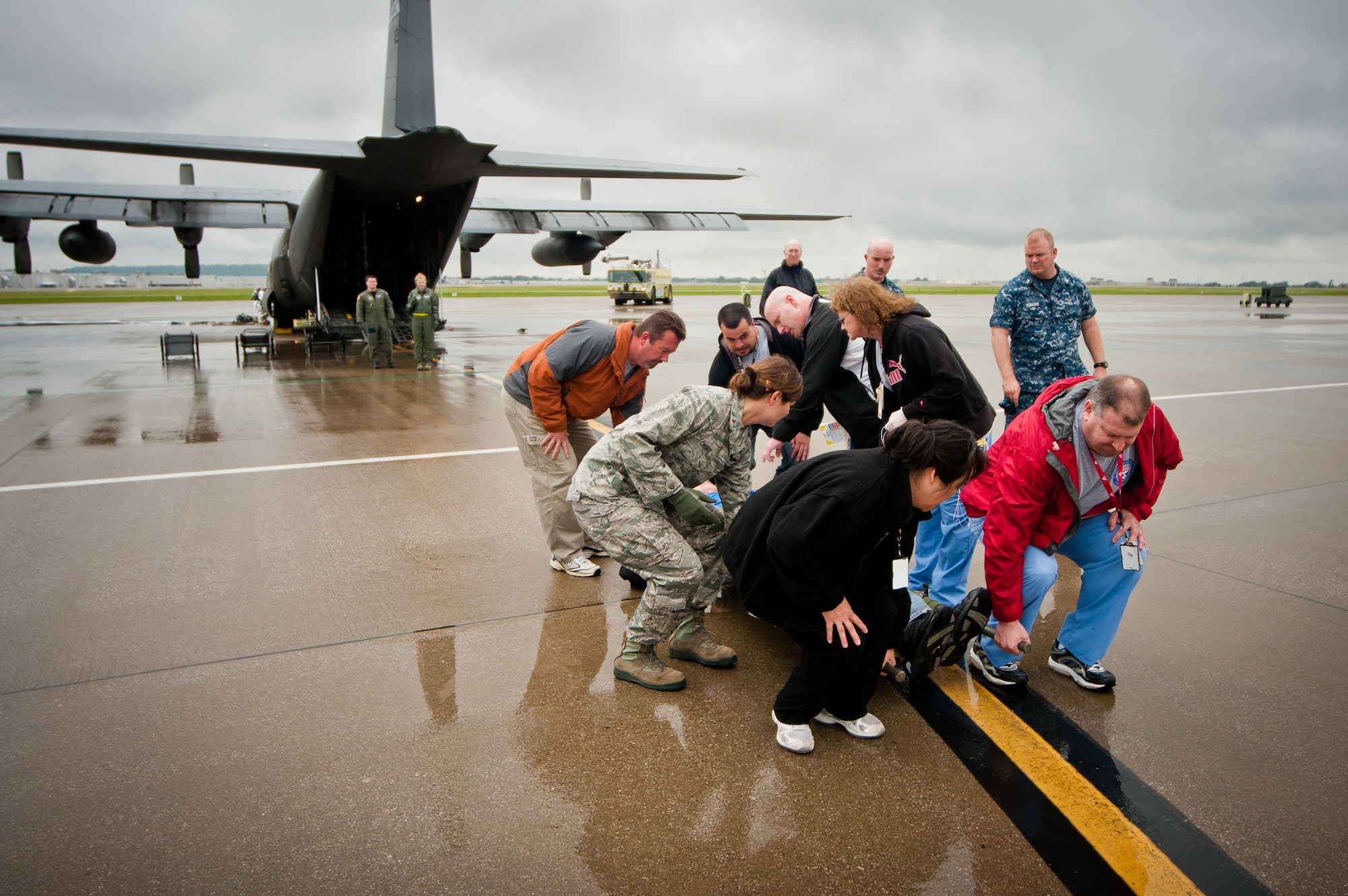 Volunteers for the National Disaster Medical System carry simulated patients off a C-130 during a earthquake-response exercise held May 18, 2011, at the Kentucky Air National Guard Base in Louisville, Ky. Operated by the U.S. Department of Health and Human Services with volunteers from multiple agencies like the Department of Veterans Affairs, NDMS was created to manage the federal government’s overall medical response to major emergencies and disasters. (U.S. Air Force photo by Maj. Dale Greer)
