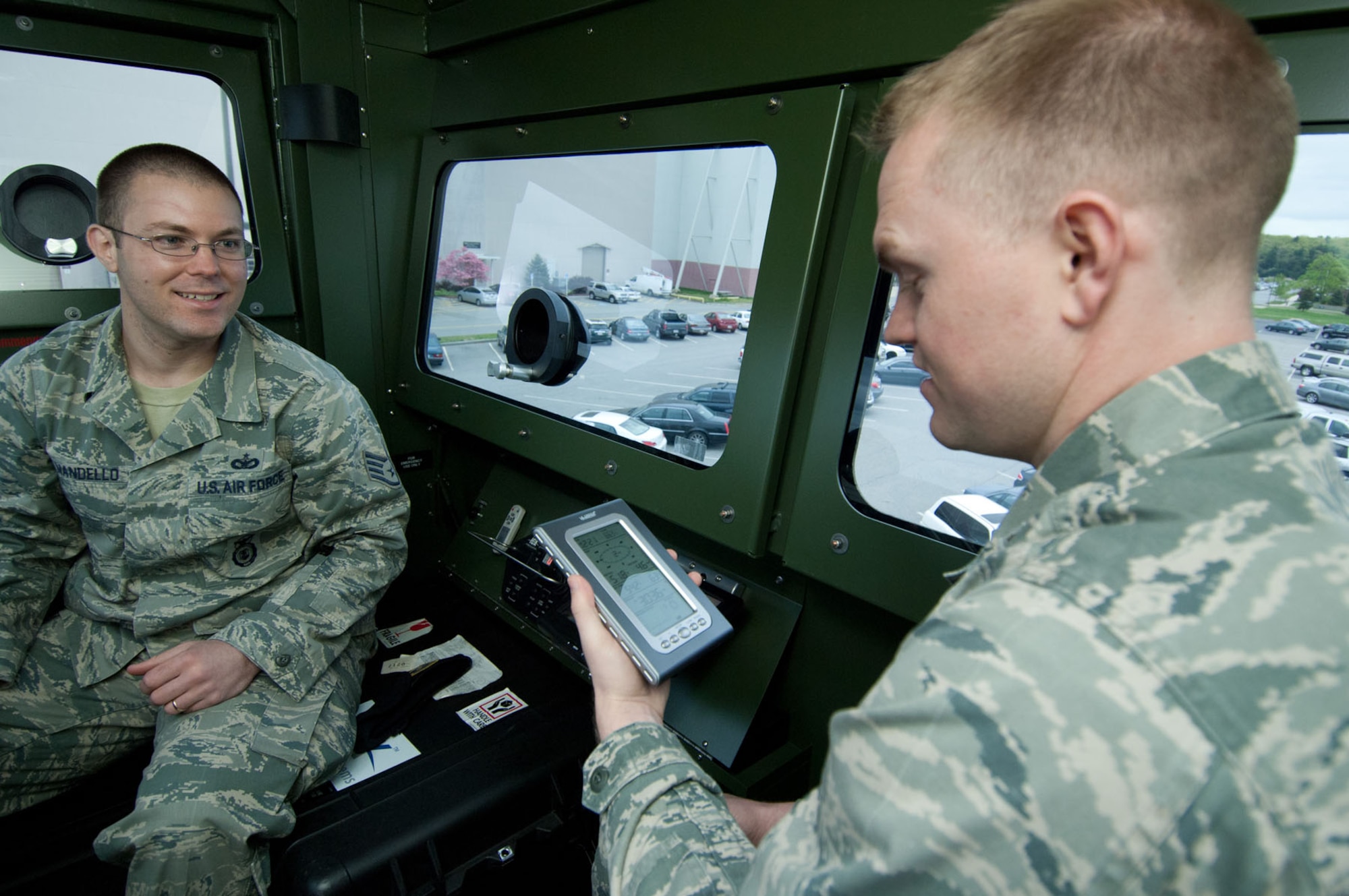 HANSCOM AIR FORCE BASE, Mass. – Staff Sgt. Michael Mandello (left), 66th Security Force Squadron, shows 2nd Lt. Brent Olson, 66th Comptroller Squadron, around some of the equipment during the equipment display in the Base Exchange parking lot May 10. The 66th Security Forces Squadron hosted many demonstrations, events and activities for Police Week May 9 through 13. Money raised during the week was given to the Air Force Security Police Association and the Domestic Violence Services Network. (U.S. Air Force photo by Rick Berry)