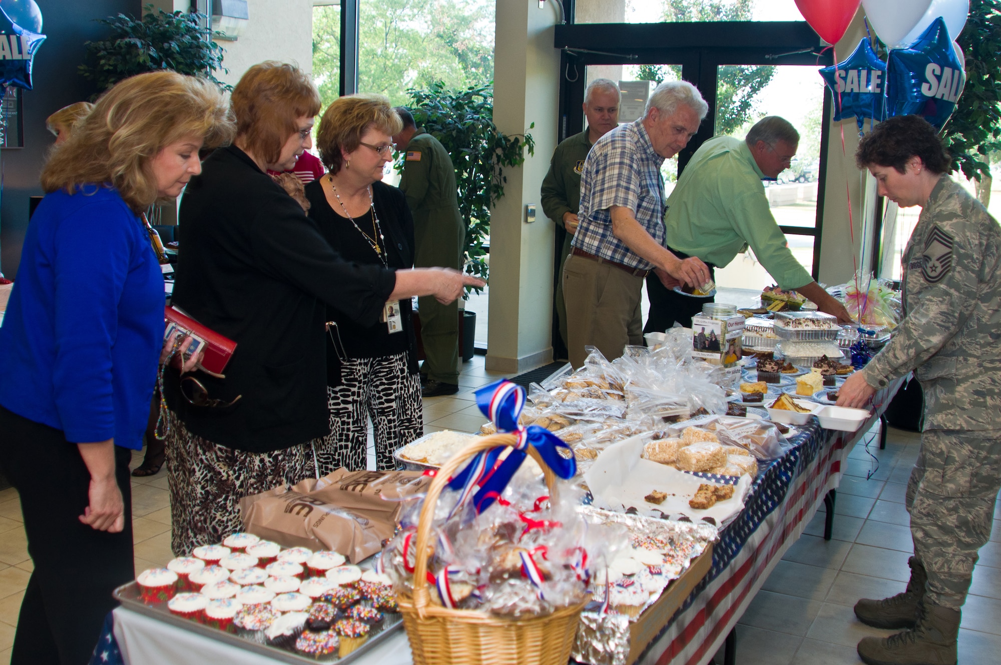 Headquarters Air Force Reserve Command personnel hosted a bake sale May 19, 2011, to support two servicemembers whose children were wounded in Afghanistan. Proceeds from the sale will go to offset medical costs for Army infantryman Cpl. Griffin Fitzgerald, son of CMSgt. Richard Brown, and Marine combat engineer Cpl. Tony Mullis, son of Master Sgt. Cozetta Quigg, who lost limbs in battle and are recovering at Walter Reed Army Medical Center, in Washington, D.C. (U.S. Air Force photo/Staff Sgt. Alexy Saltekoff)