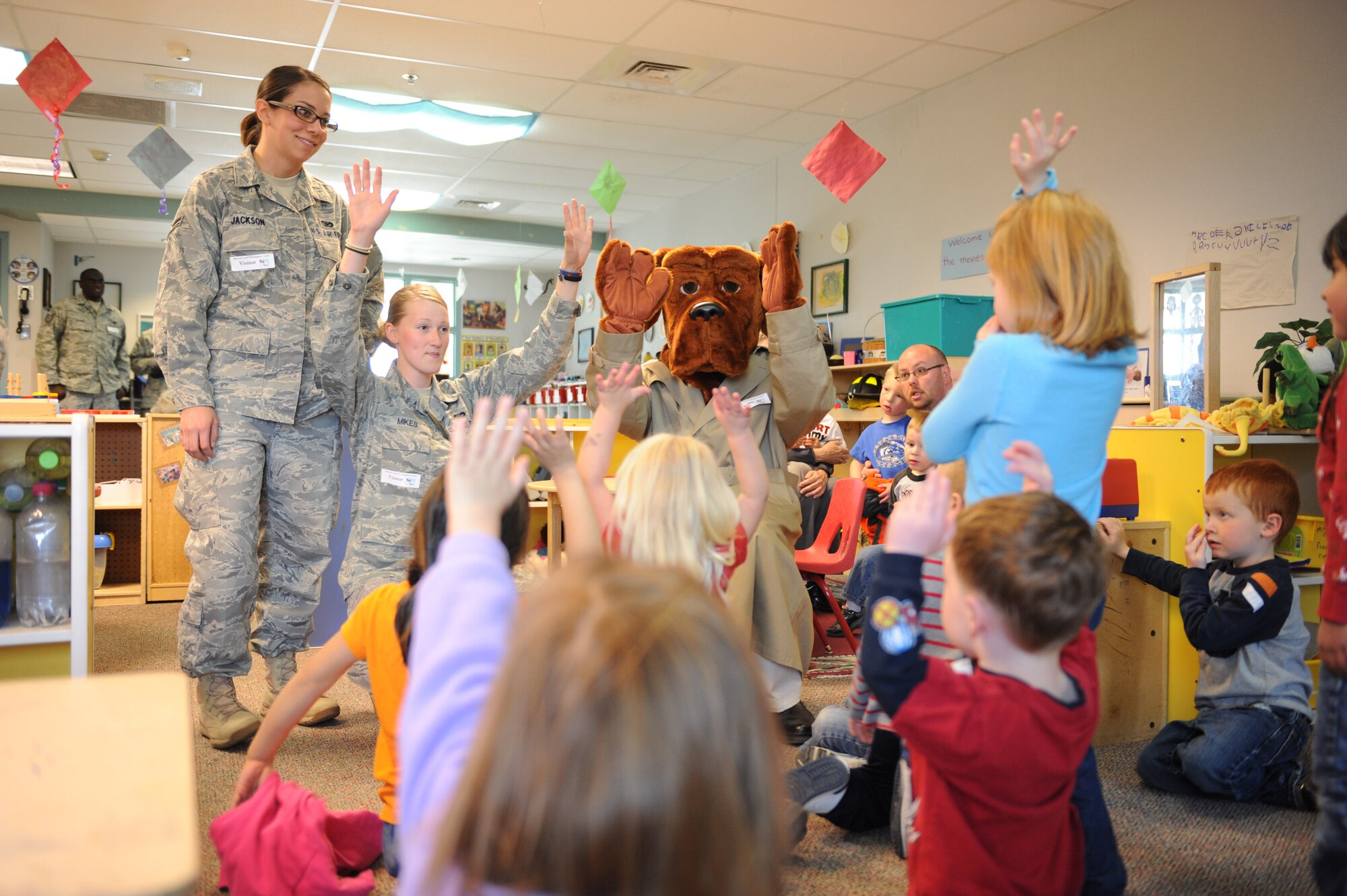 (Left) Airmen 1st Class Alexandra Jackson, and Shandi Mikes, 28th Security Forces Squadron patrolmen and Scruff McGruff the crime dog interact with children at the Child Development Center at Ellsworth Air Force Base, SD., May 17. Airmen Jackson and Mikes taught the group of kid’s crime fighting techniques such as not bullying, stranger danger and safety techniques for riding bicycles. (U.S. Air Force photo/ Senior Airman Adam Grant)