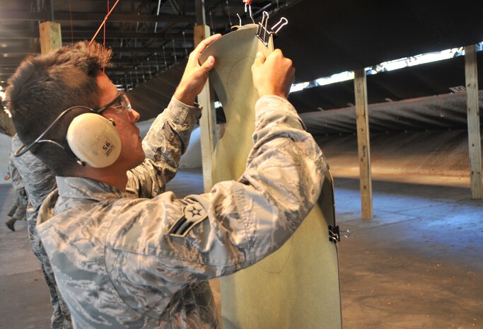 Airman 1st Class German Cubero, a 628th Civil Engineering Squadron water and fuel maintenance system technician and a 628th Security Forces Squadron augmentee, hangs a target during an M-9 qualification training May 18, at Joint Base Charleston – Air Base. More than 25 Security Forces augmentees participated in the qualification. Special thanks to all of the men and women who took into account ‘service before self’ by volunteering to become an augmentee during a time of need. 