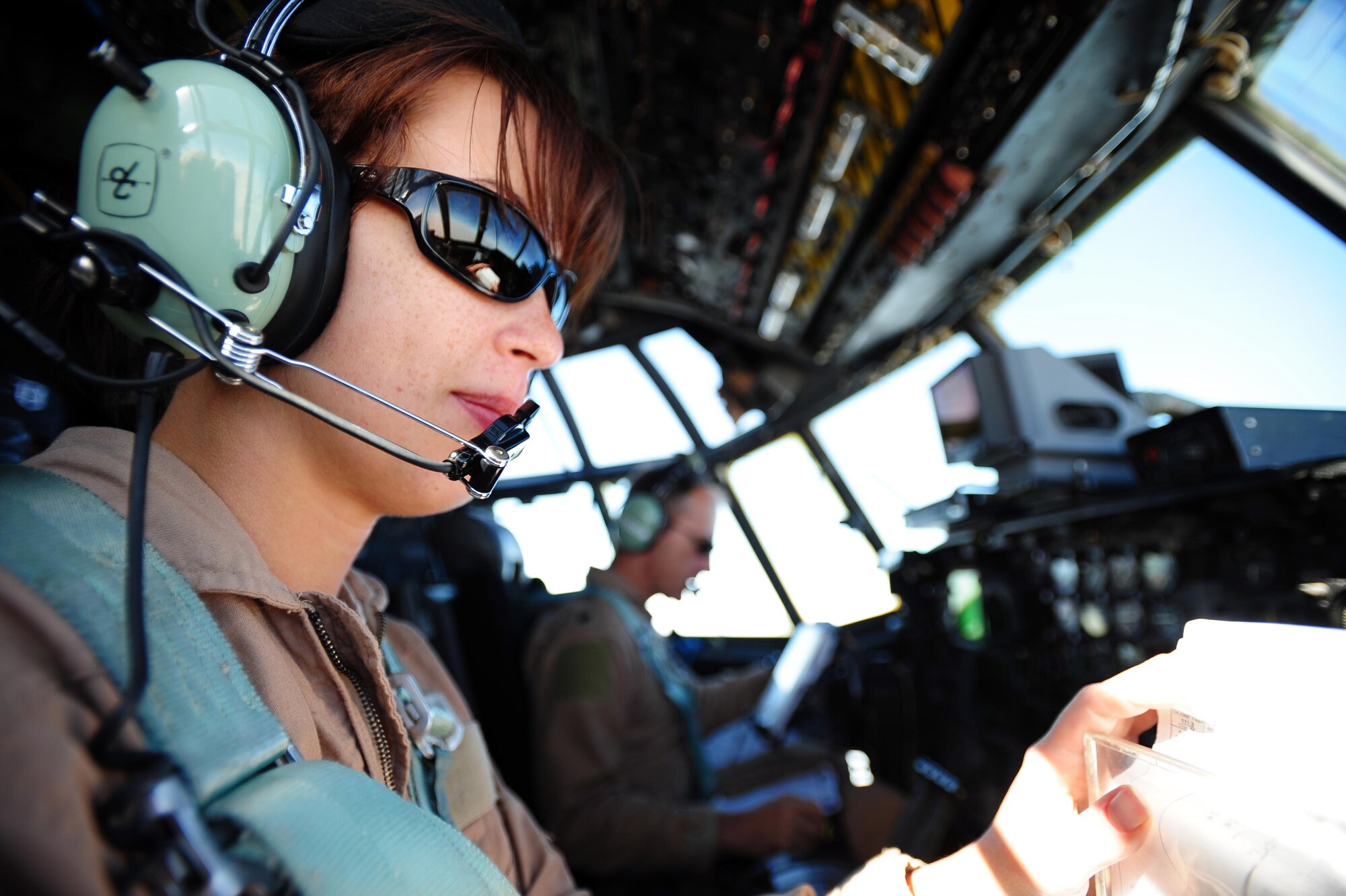 First Lt. Lindsay Volaski, 746th Expeditionary Airlift Squadron pilot, reviews her flight plan aboard a C-130 Hercules on an aeromedical evacuation mission supporting Operation New Dawn over Iraq, May 5, 2011. 