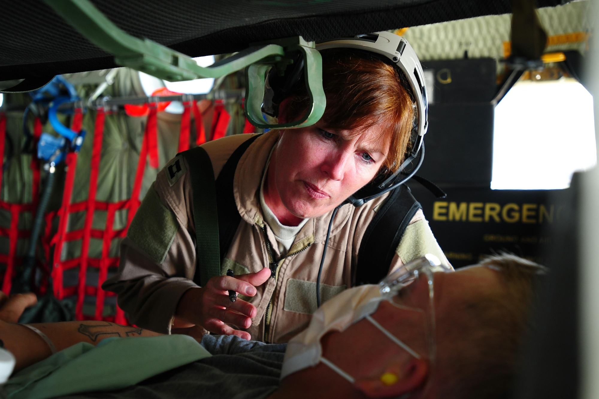 Capt. Rita O'Brian, 379th Expeditionary Aeromedical Evacuation Squadron flight nurse, checks on a patient aboard a C-130 Hercules during an aeromedical evacuation mission in Iraq supporting Operation New Dawn, May 5, 2011. 