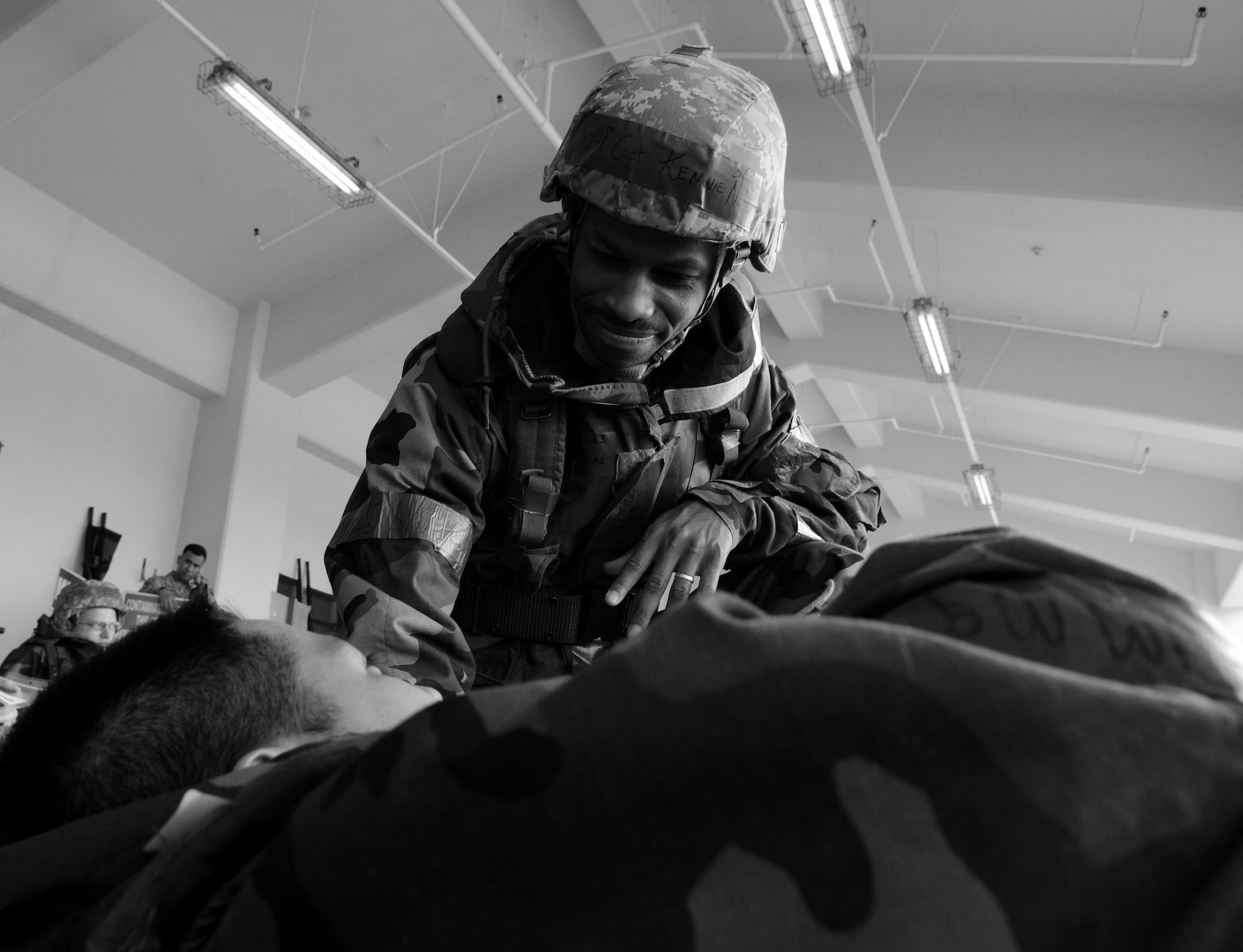 Chaplain (Capt.) Kennie Neal, 18th Wing chaplain, gives words of encouragement to simulated "food poisoning" victim, during a local operational readiness exercise, Beverly High 11-04, at Kadena Air Base, Japan, May 19. Kadena's personnel are participating in the LORE to stay prepared for real world contingencies. (U.S. Air Force photo/Airman 1st Class Jarvie Z. Wallace)