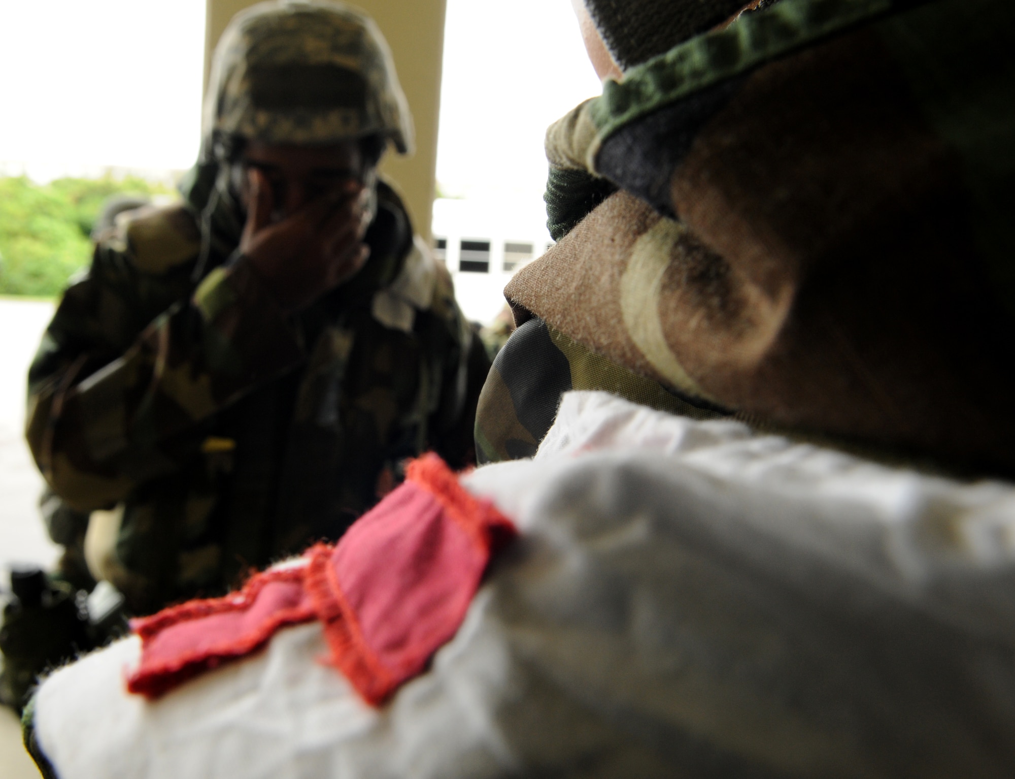 A simulated ''food poisoning" victim holds back tears after speaking with a medical technician from the 18th Medical Support Squadron during Bevrly High 11-04, a local operational readiness exercise, at Kadena Air Base, Japan, May 19. Kadena's 18th Medical Group uses exercises to prepare for operational readiness inspections, and potential real-world emergencies. (U.S. Air Force photo/Airman 1st Class Jarvie Z. Wallace)