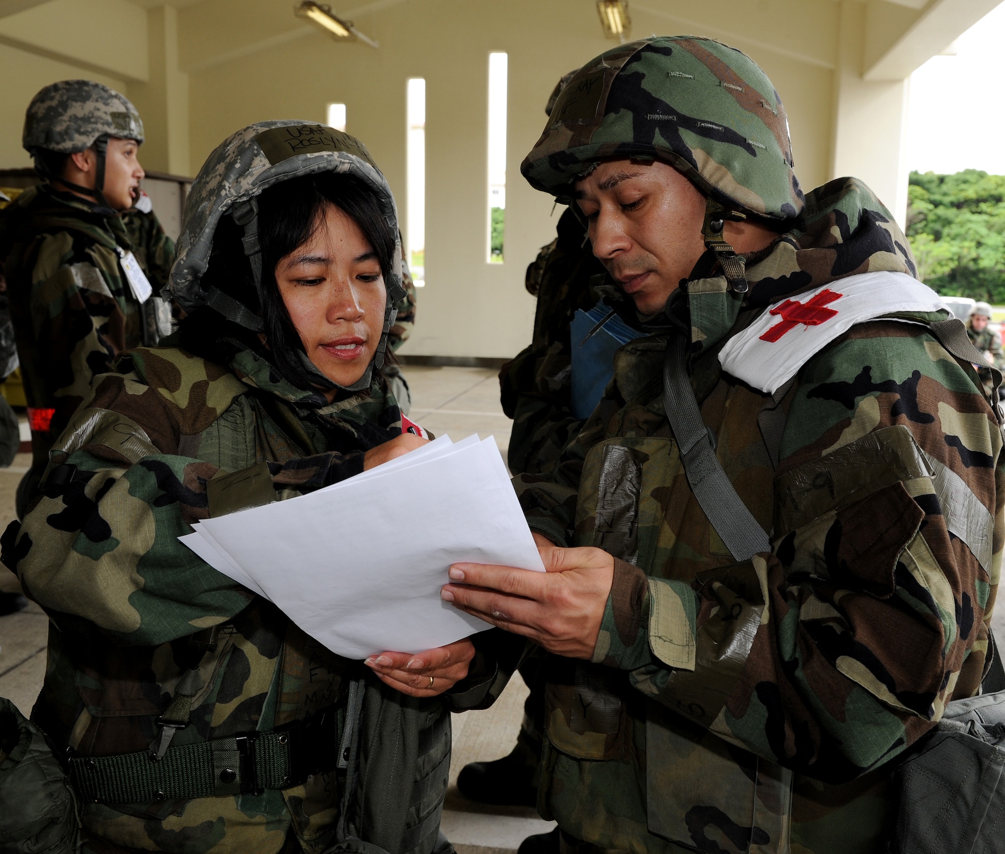 Major Roslyn Thomas (left), 18th Medical Group, checks patient’s information with Staff Sgt. Raymond Wrentmore (right), 18th Medical Support Squadron, at the exercise contamination control center area after a mass food poisoning scenario as part of local operational readiness exercise Beverly High 11-4, May 19, at Kadena Air Base, Japan. Kadena's personnel are participating in the LORE to stay prepared for real world contingencies. (U.S. Air Force photo/Junko Kinjo)
