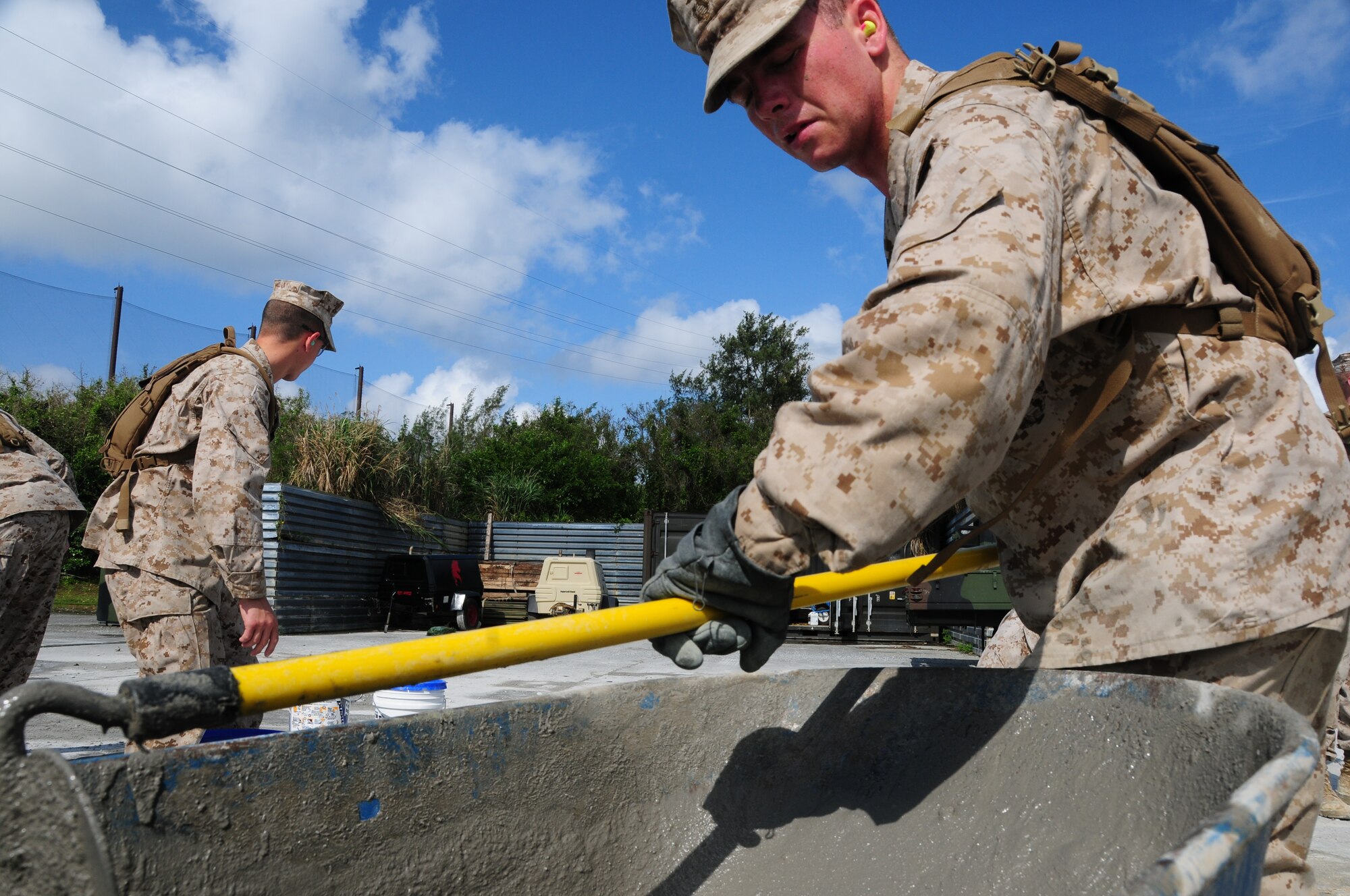 Marines assigned to Camp Foster's Marine Wing Support Squadron 172 mix quick-drying cement as they work against the clock to repair spalled concrete at Kadena's Silver Flag site. The air base's 554th RED HORSE Squadron hosted a week-long training camp for the Marines, teaching techniques in heavy equipment operation and rapid runway repair methods unique to the Air Force. (U.S. Air Force photo/Senior Airman Shaunlee Hostutler)