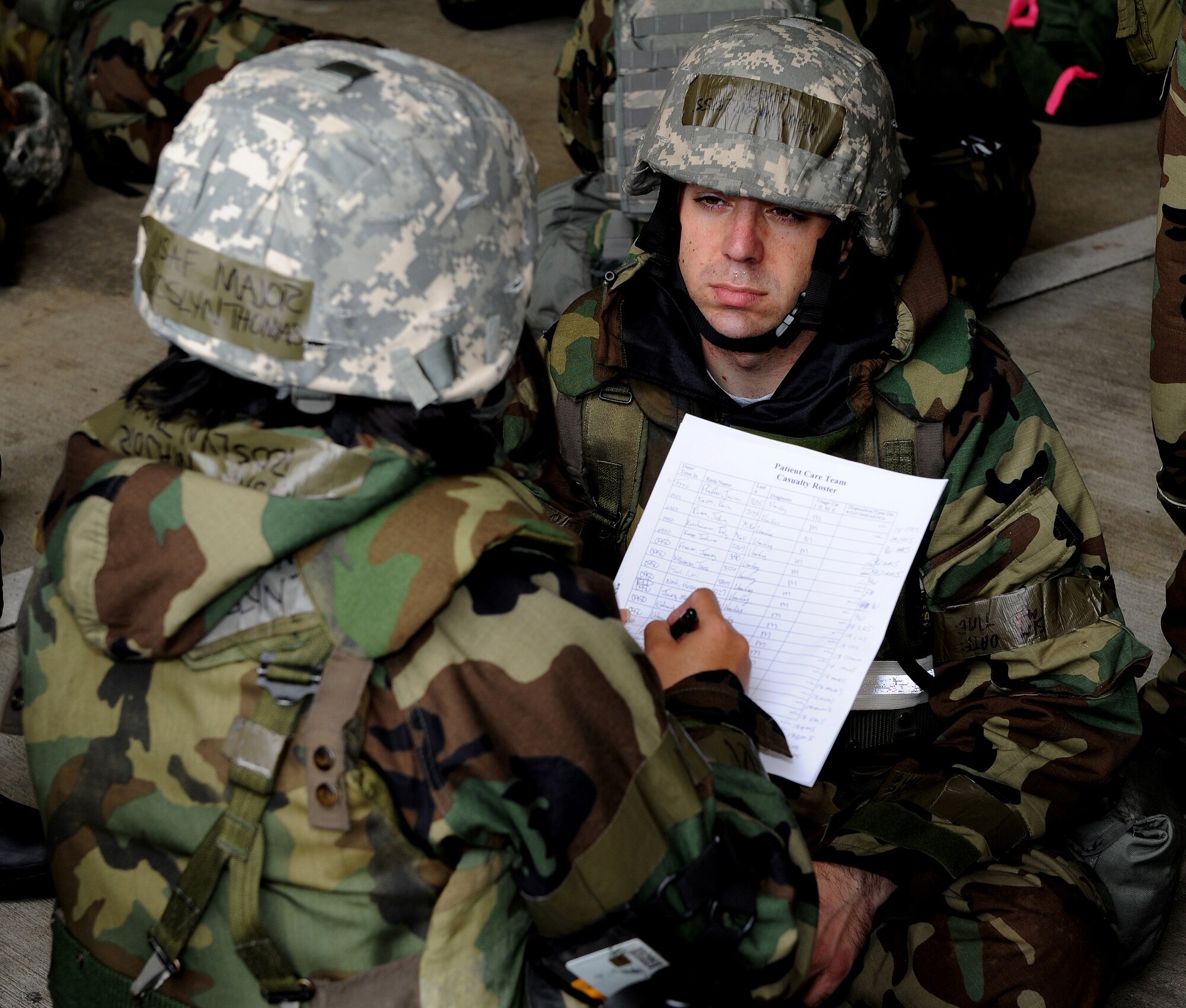 Staff Sgt. Joshua Knepp (right), 961st Airborne Air Control Squadron, is treated for food poisoning at the exercise contamination control center by Major Roslyn Thomas, 18th Medical Group (left) as part of local operational readiness exercise Beverly High 11-4, May 19, at Kadena Air Base, Japan. Kadena's personnel are participating in the LORE to stay prepared for real world contingencies. (U.S. Air Force photo/Junko Kinjo)