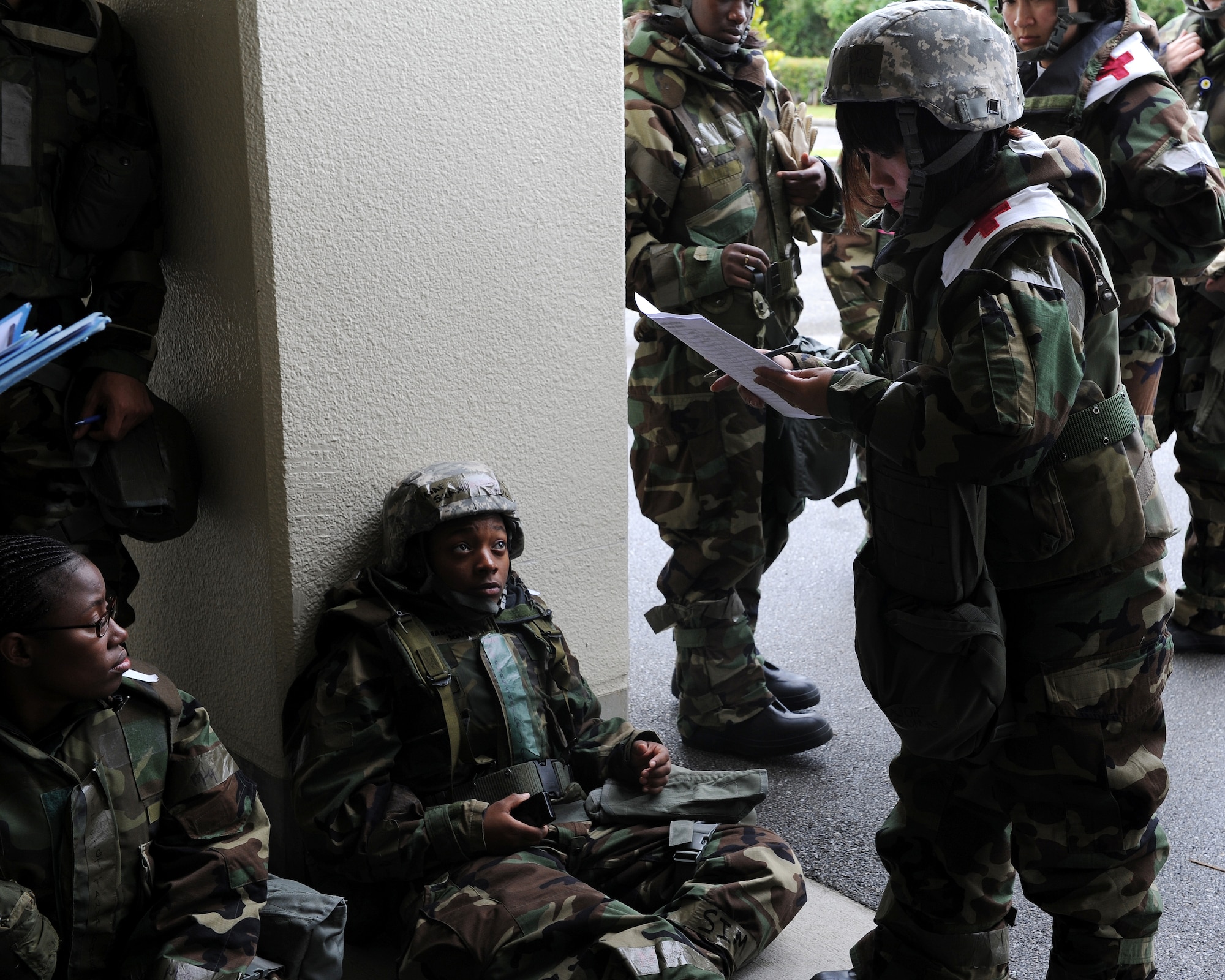 Major Roslyn Thomas, 18th Medical Group, checks up on patients at the exercise contamination control center who are simulating a mass food poisoning incident as part of local operational readiness exercise Beverly High 11-4, May 19, at Kadena Air Base, Japan. Kadena's personnel are participating in the LORE to stay prepared for real world contingencies. (U.S. Air Force photo/Junko Kinjo)