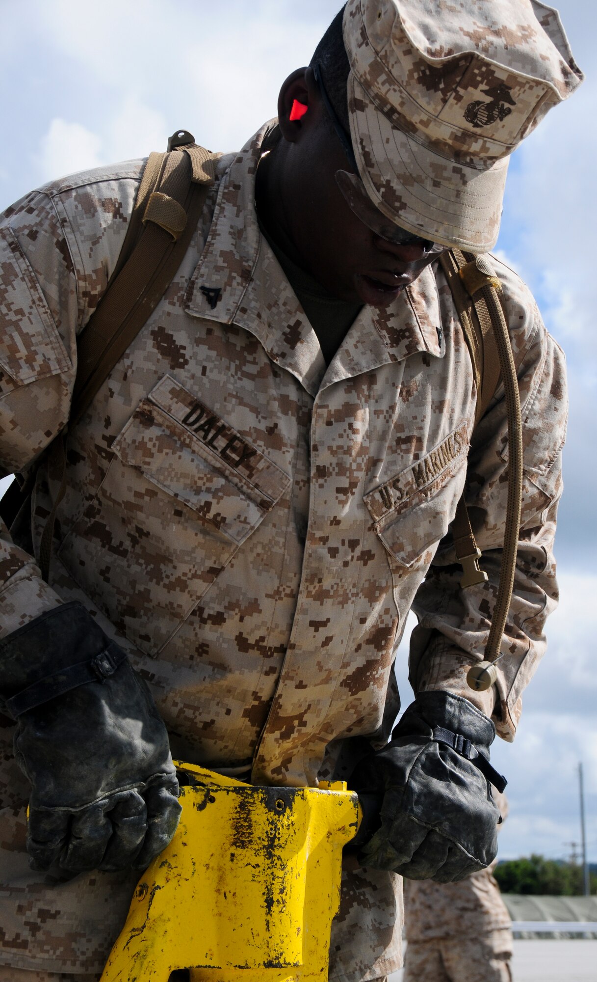 Marines assigned to Camp Foster's Marine Wing Support Squadron 172 break a sweat as the work against the clock to repair spalled concrete at Kadena's Silver Flag site. The air base's 554th RED HORSE Squadron hosted a week-long training camp for the Marines, teaching techniques in heavy equipment operation and rapid runway repair methods unique to the Air Force. (U.S. Air Force photo/Senior Airman Shaunlee Hostutler)