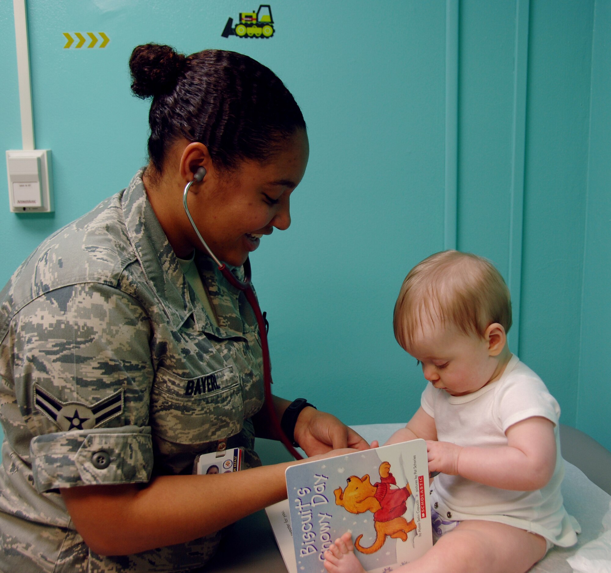 YOKOTA AIR BASE, Japan -- Airman 1st Class Cassandra Bayerl, 374th Medical Operatons Squadron medical technician, shows a stethoscope to Matthew Nichols, son of Senior Airman Adam Nichols, during his nine-month check-up at Yokota Air Base, Japan, May 13, 2011. Airman Bayrel spends her days greeting young patients at the pediatric clinic and gathering information about the patient. (U.S. Air Force Photo/Airman 1st Class Katrina R. Menchaca)