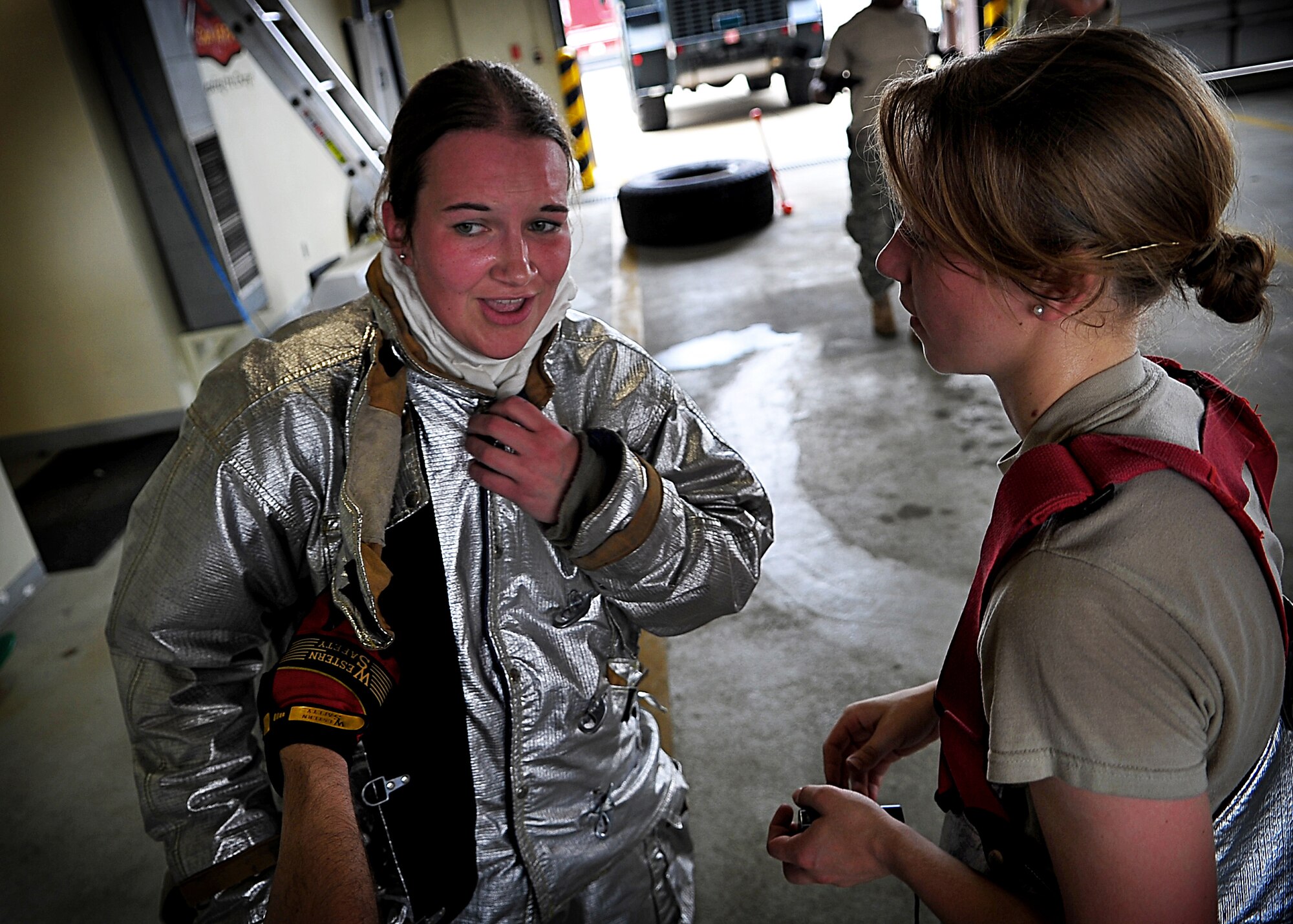 Cadets 3rd class Victoria Cachro and Randi Imerman (L-R) talk after the firefighters physical training challenge.  U. S. Air Force Academy cadets participated in field training with 51st Civil Engineer firefighters May 18.