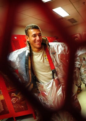Cadet 2nd Class Mathew Bell suits up for the firefighters physical training challenge.
 U. S. Air Force Academy cadets participated in field training with 51st Civil Engineer firefighters at Osan Air Base May 18.