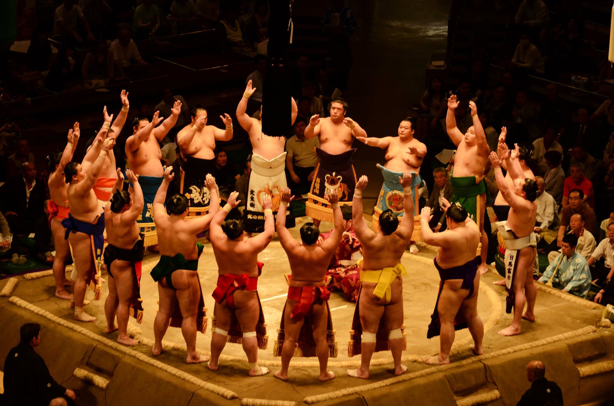YOKOTA AIR BASE, Japan - Sumo wrestlers gather to perform the Dohyo-iri, the formal ring entering ceremony performed by members of the top two divisions in Sumo at the Ryogoku Kokugikan, Tokyo, Japan, May 14, 2011. More than 150 members of the team Yokota family were invited by a Fussa Friendship Club member. (Courtesy Photo)