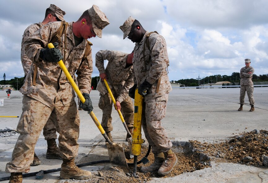 2nd Lt. Ruth Kelty, the Engineer Operations Company commander, proudly supervises junior Marines assigned to Camp Foster's Marine Wing Support Squadron 172 as they repair spalled concrete at Kadena's Silver Flag site. The air base's 554th RED HORSE Squadron hosted a week-long training camp for the Marines, teaching techniques in heavy equipment operation and rapid runway repair methods unique to the Air Force. Lieutenant Kelty says she couldn't be prouder of her Marines and how well they've come together during the training event. (U.S. Air Force photo/Senior Airman Shaunlee Hostutler)
