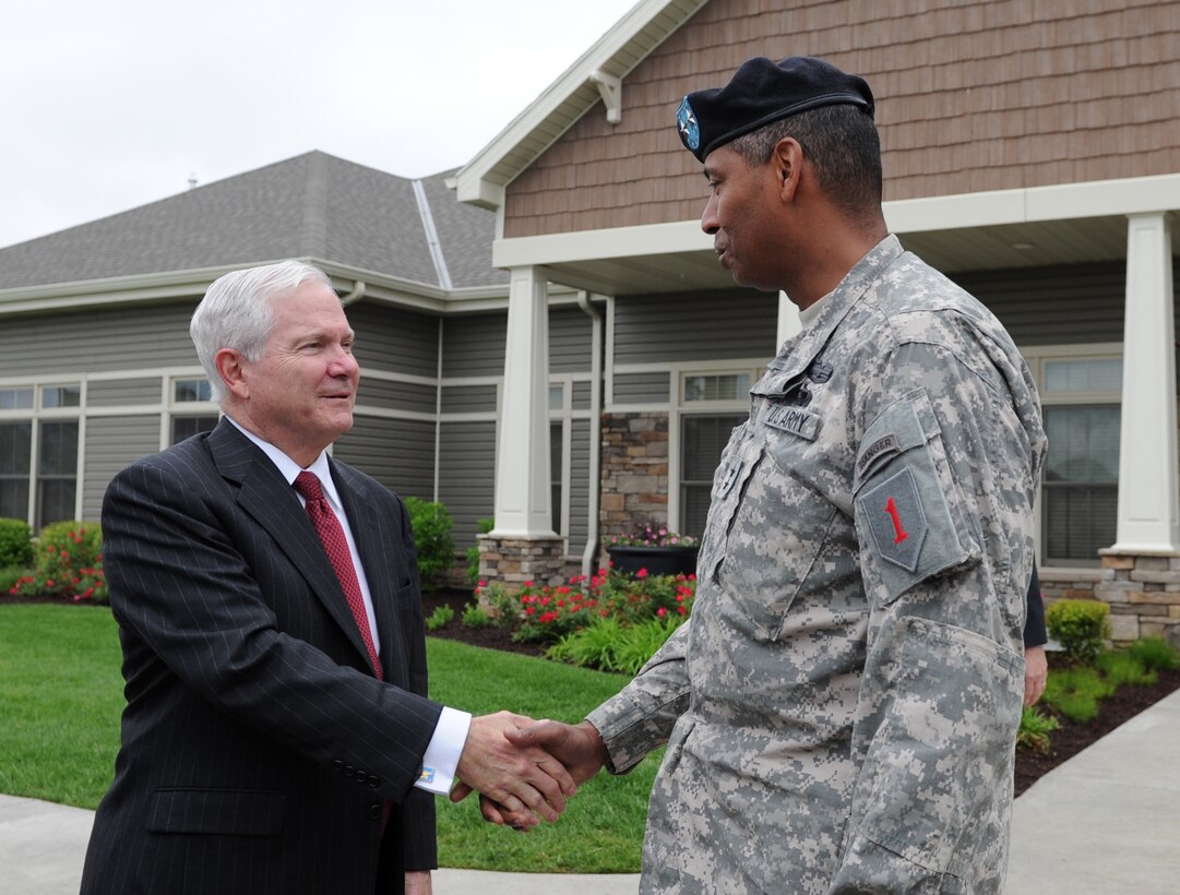 Defense Secretary Robert M. Gates shakes hands with Army Maj. Gen. Vincent Brooks, commanding general of the 1st Infantry Division, in front of the newly opened Forsyth Neighborhood Center on Fort Riley, Kan., May 19, 2011.  