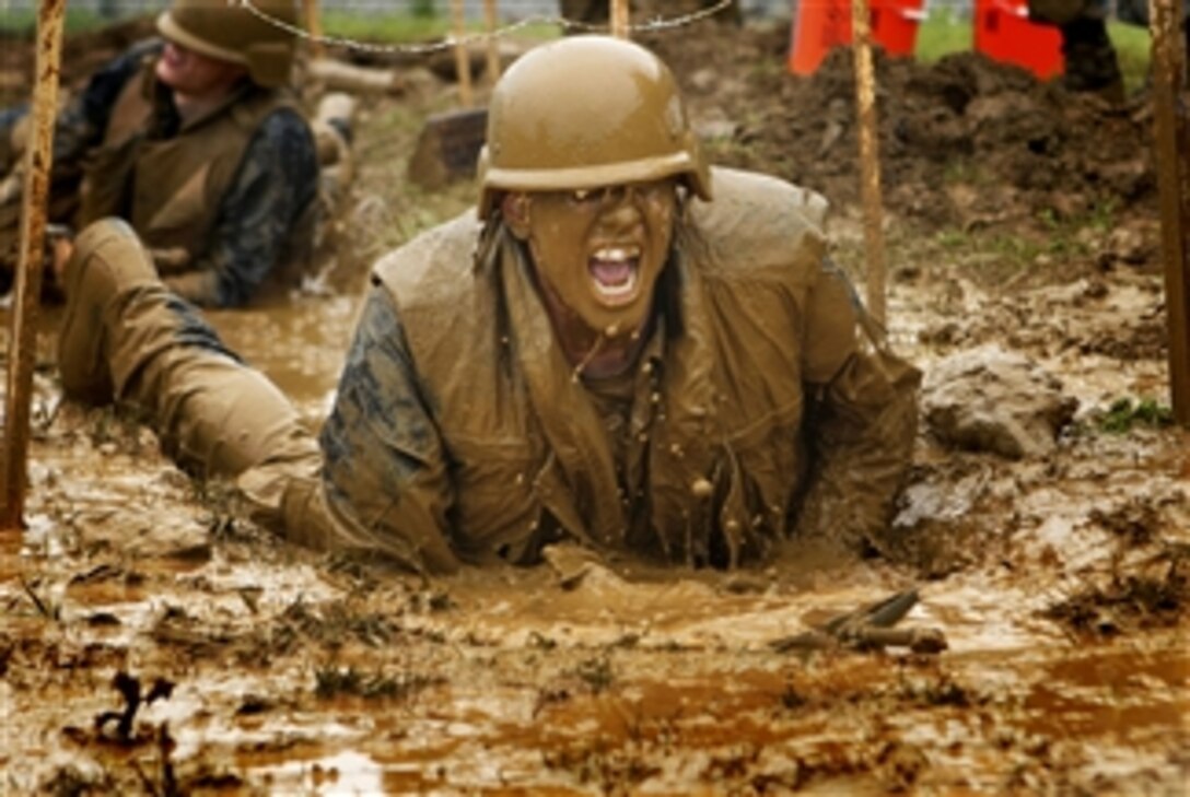 U.S. Naval Academy plebes navigate the low crawl obstacle during Sea Trials, the capstone training exercise for Naval Academy freshmen in Annapolis, Md., on May 17, 2011. The plebes navigate physical and mental challenges, ranging from obstacle courses, long-distance group runs, damage control scenarios and water training to challenge them individually and as a team.  