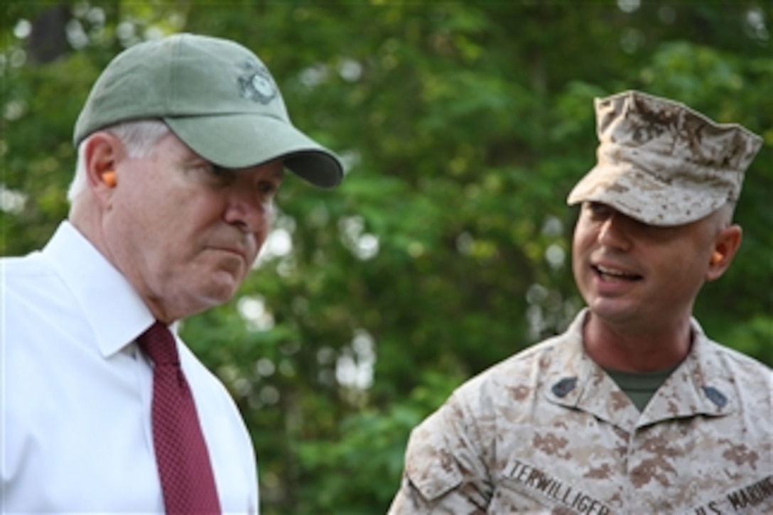 Secretary of Defense Robert M. Gates (left) talks to U.S. Marine Corps Gunnery Sgt. Gregory B. Terwilliger (right) about the Crucible, new Marines' initial training, at Marine Corps Recruit Depot, Parris Island, S.C., on May 13, 2011.  Gates visited the depot to see how recruit training was conducted.  