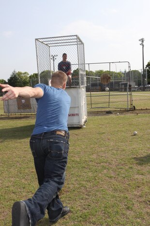 Lance Cpl. Austin Mckenna, Installation Personnel Administration Center personnel clerk, attempts to dunk his Executive Officer Maj. Travis K. Brittain during Kid’s Day at the Monzen side baseball field here May 20.