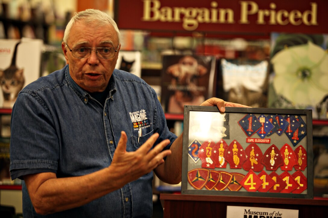 JACKSONVILLE, N.C.—Retired Col. Bill Ayers, interim executive director of the Museum of the Marine, describes Marine Corps unit patches during a talk about the history of military uniforms at Barnes and Noble, May 20.  The Museum of the Marine held a book fair and living history display to raise funds and awareness.