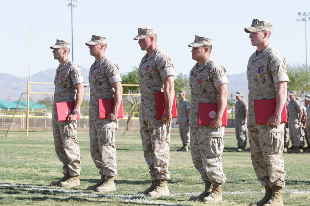 (From left) Cpl Patrick Rowe, Lance Cpl. Jose Velasquez, Cpl. Edward Huth and Maj. Patrick McKinley, who received Bronze Stars and Lance Cpl. Brian Murphy who received a Purple Heart, stood proud with their awards in hand and medals on their chest at their award ceremony at Felix Field May 27, 2011.