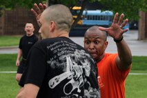 Staff Sgt. David M. Simons, Recruiting Substation Bismarck, tries to warn Staff Sgt. Chad A. Irwin, Recruiting Substation Eau Claire, before Staff Sgt. Larry C. Kemp, Recruiting Station Twin Cities logistics chief, arrives and stops the play during the Recruiting Station Twin Cities Flag Football Tournament May 20. Irwin, 30, is from Sioux City, Iowa, and Kemp is a 34-year-old Flint, Mich., native. For additional imagery from the event, visit www.facebook.com/rstwincities.