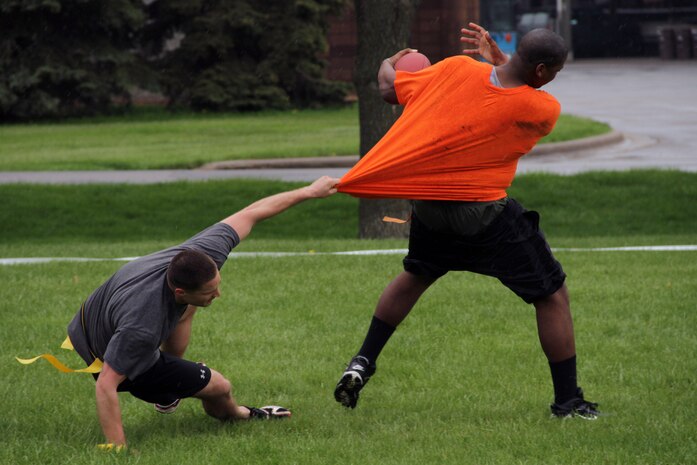 Lance Cpl. James M. Pinales, 23, from St. Louis, tries to slow down Sgt. Brandon C. Stott, Recruiting Substation Coon Rapids, until one of his teammates can catch up during the Recruiting Station Twin Cities Flag Football Tournament May 20. Stott is a 26-year-old Palm Beach, Fla., native. For additional imagery from the event, visit www.facebook.com/rstwincities.