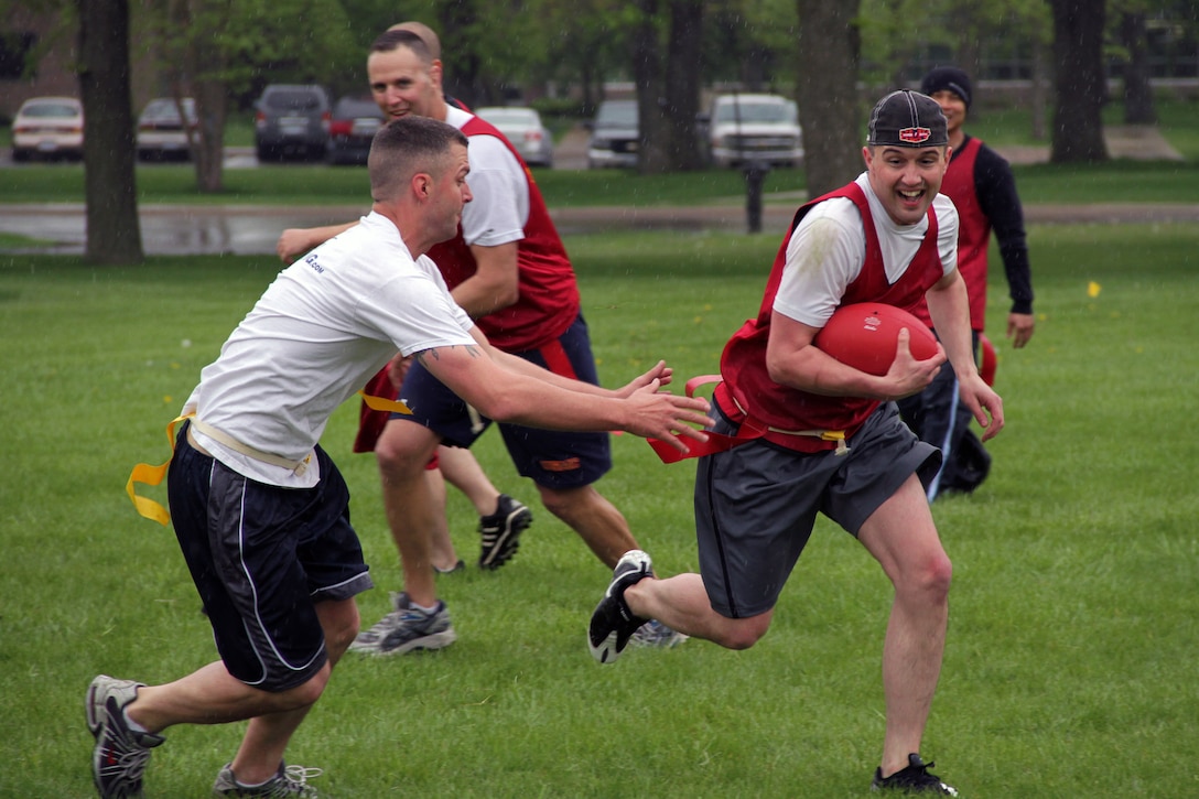 Recruiting Substation Woodbury's Staff Sgt. Scott B. Cole, 29, from Prior Lake, Minn., lunges for Staff Sgt. Jeremy G. Johnson during the Recruiting Station Twin Cities Flag Football Tournament May 20. Johnson, 28, from Purvis, Miss., is a military entrance processing station liaison in Minneapolis. For additional imagery from the event, visit www.facebook.com/rstwincities.