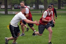 Recruiting Substation Woodbury's Staff Sgt. Scott B. Cole, 29, from Prior Lake, Minn., lunges for Staff Sgt. Jeremy G. Johnson during the Recruiting Station Twin Cities Flag Football Tournament May 20. Johnson, 28, from Purvis, Miss., is a military entrance processing station liaison in Minneapolis. For additional imagery from the event, visit www.facebook.com/rstwincities.