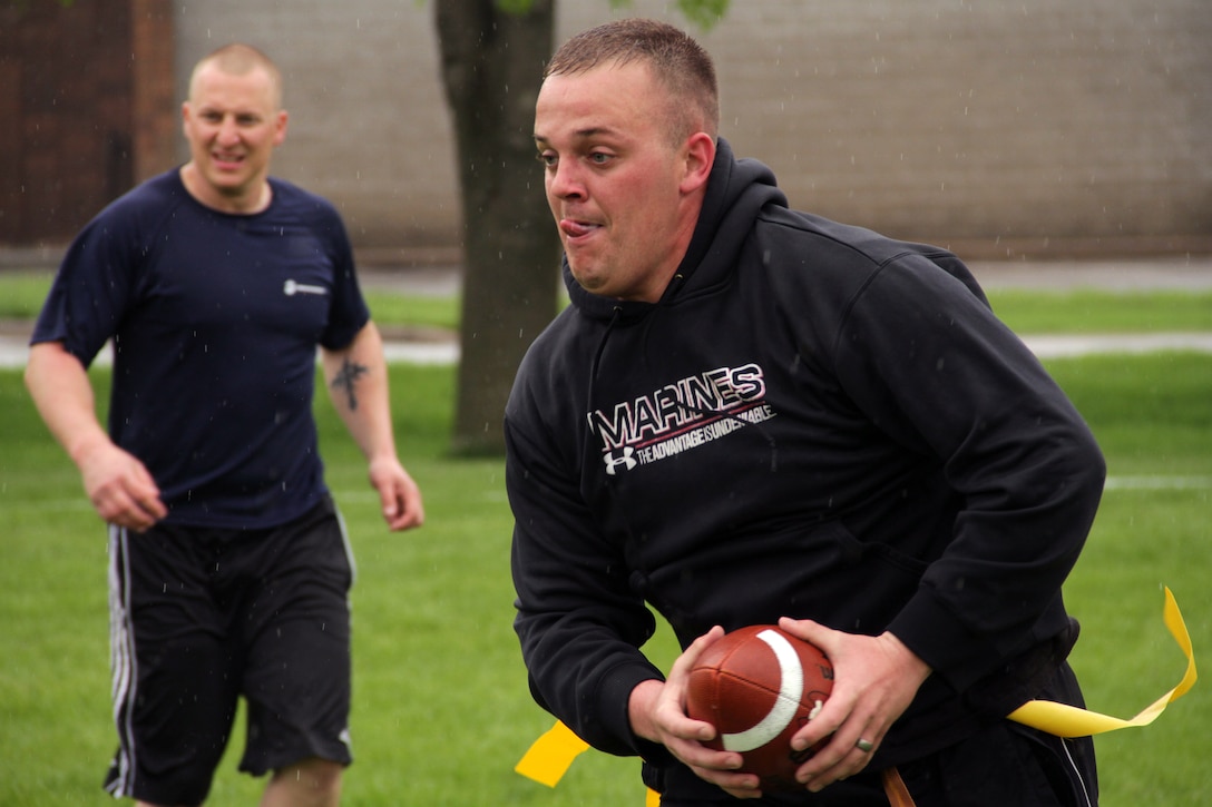 Staff Sgt. Gary L. McCoy, Recruiting Substation St. Cloud, watches Sgt. Nicholas K. Metcalf, Recruiting Substation Eau Claire, drive toward an open lane during the Recruiting Station Twin Cities Flag Football Tournament May 20. McCoy is 25-year-old Tulelake, Calif., native and Metcalf, 25, is from Kenyon, Minn. For additional imagery from the event, visit www.facebook.com/rstwincities.