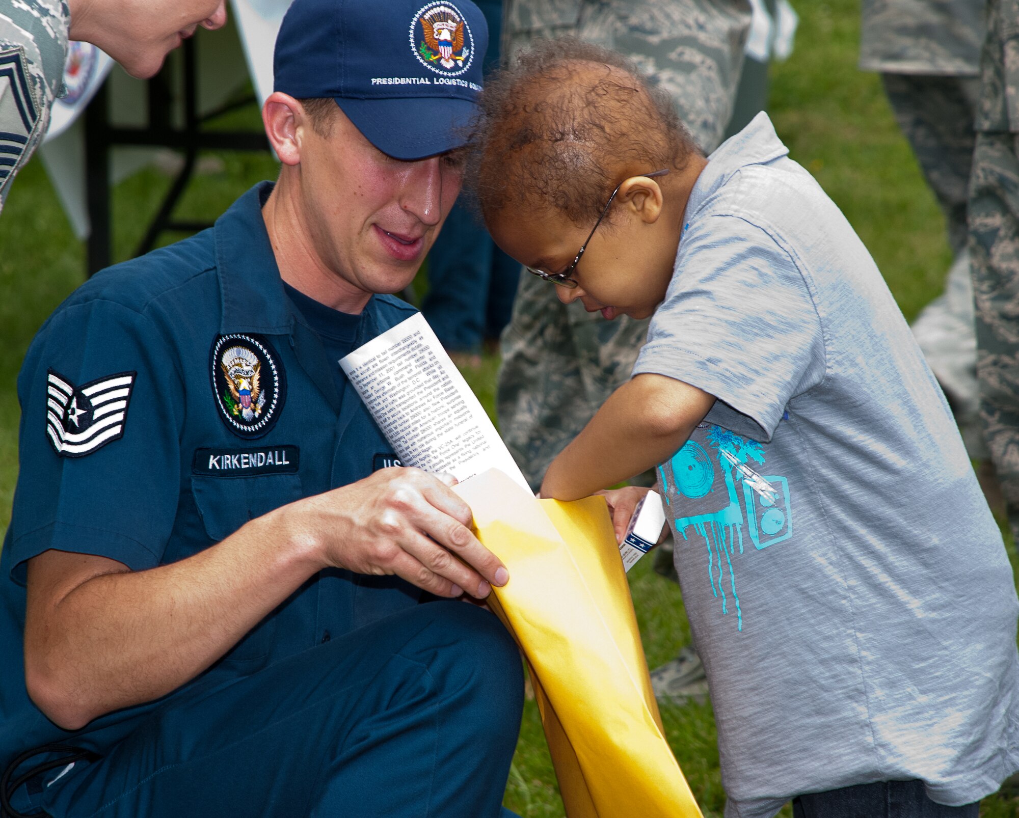 JOINT BASE ANDREWS, Md. --Tech. Sgt. Michael Kirkendall, Presidential Logistics Squadron communication navigator gives special Air Force One M&M’s to Elijah Davis, Pilot for a Day alum here May 20. The 201st Airlift Wing, The 113th Wing and The 459th Air Refueling Wing sponsored the Pilot for a Day 2011 Reunion here during the Joint Service Open House. The Pilot for a Day program offers children with serious illnesses a special day to be an Air Force pilot, giving them a break from whatever challenges they may face. (U.S. Air Force photo/ Staff Sgt. Sophia Piellusch)