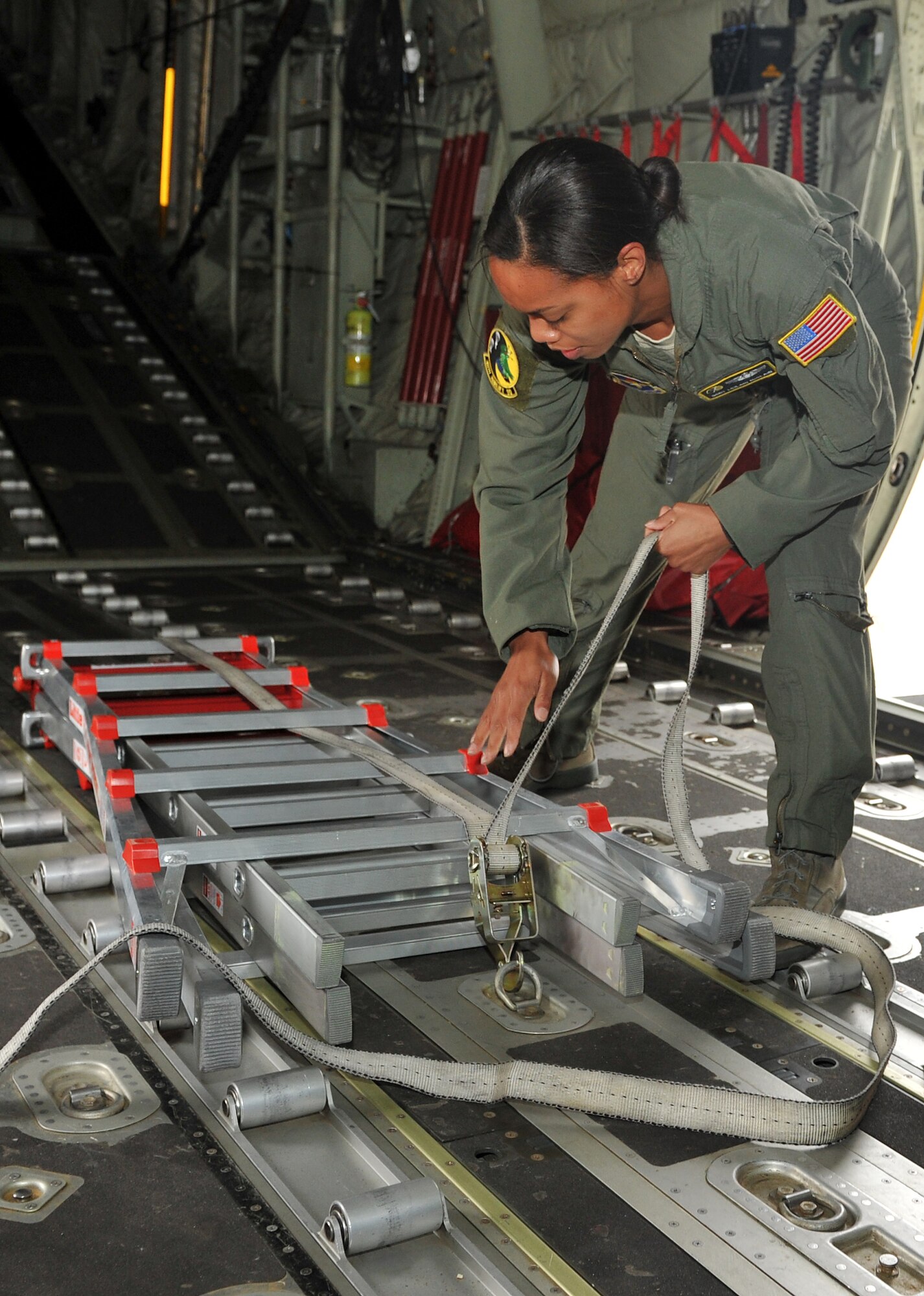 Staff Sgt. Leilani McClain, a 48th Airlift Squadron loadmaster, performs a cargo strap-down on a C-130 Hercules May 16, 2011, at Little Rock Air Force Base, Ark. Sergeant McClain was handpicked to represent the 314th Airlift Wing during the international RODEO competition.  (U.S. Air Force photo/Staff Sgt. Chris Willis) 
