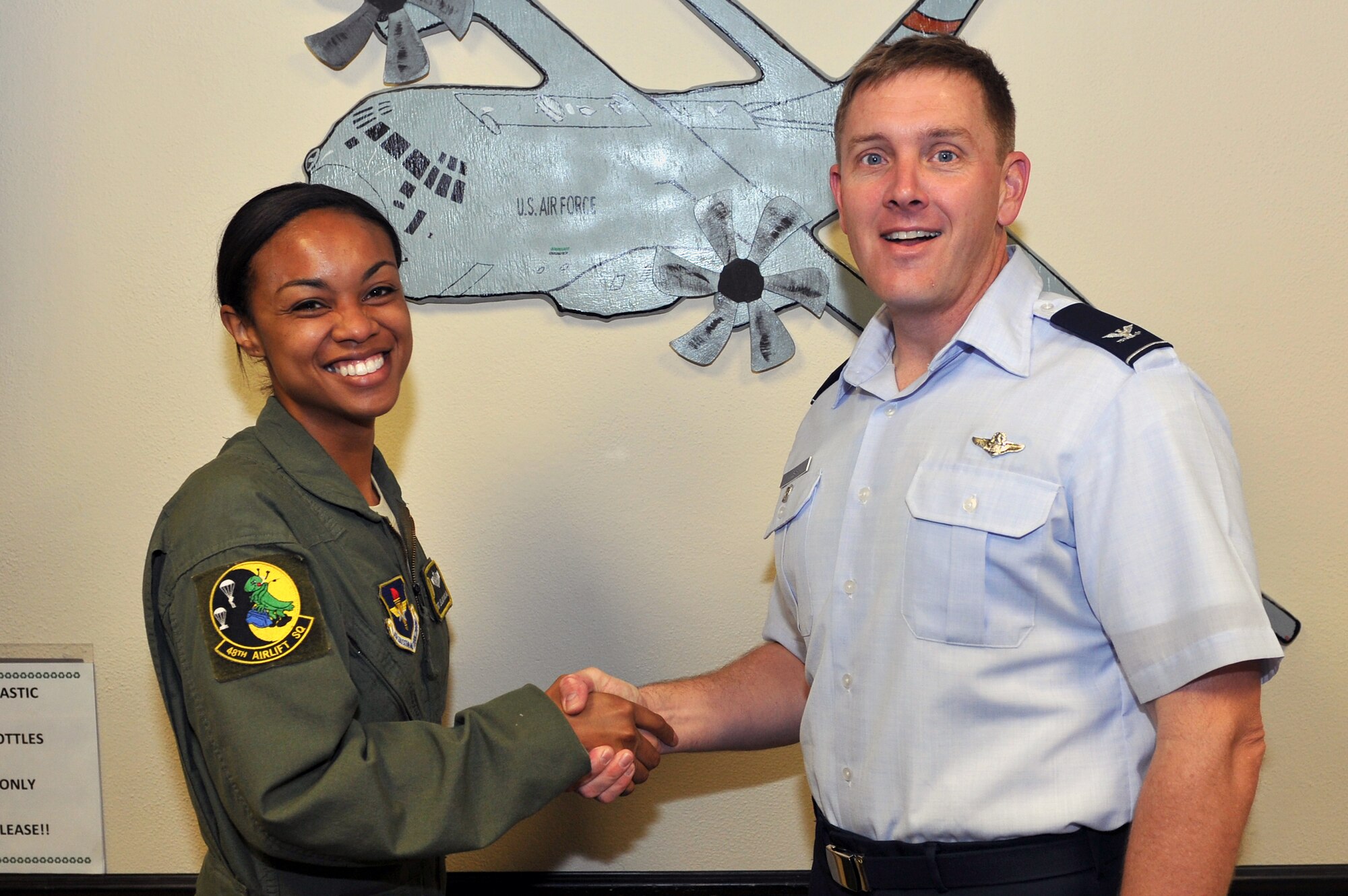 Col. Kirk Lear (right), 314th Airlift Wing vice commander, presents a commander’s coin May 16, 2011, at Little Rock Air Force Base, Ark., to Staff Sgt. Leilani McClain, a 48th Airlift Squadron loadmaster, for her selection as the Combat Airlifter of the Week. Sergeant McClain oversaw 11 permanent party upgrades and created a loadmaster common student errors training guide. (U.S. Air Force photo/Staff Sgt. Chris Willis)
 
