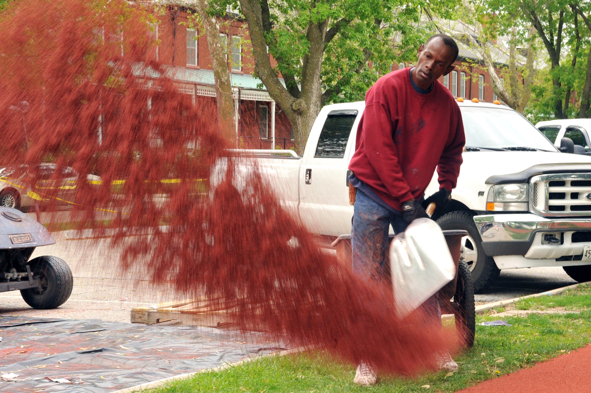 OFFUTT AIR FORCE BASE, Neb. -- Mike Anderson of Bynon Sports, mixes a bucket of top coat to be used as primer before laying a rubber surface on the track around the parade field at Offutt Air Force Base on May 18.  Bynon Sports, which is located in Hunt Valley, Maryland was contracted to cover the concrete track at the Offutt parade field with a rubber surface. U.S. Air Force Photo by D.P. Heard
