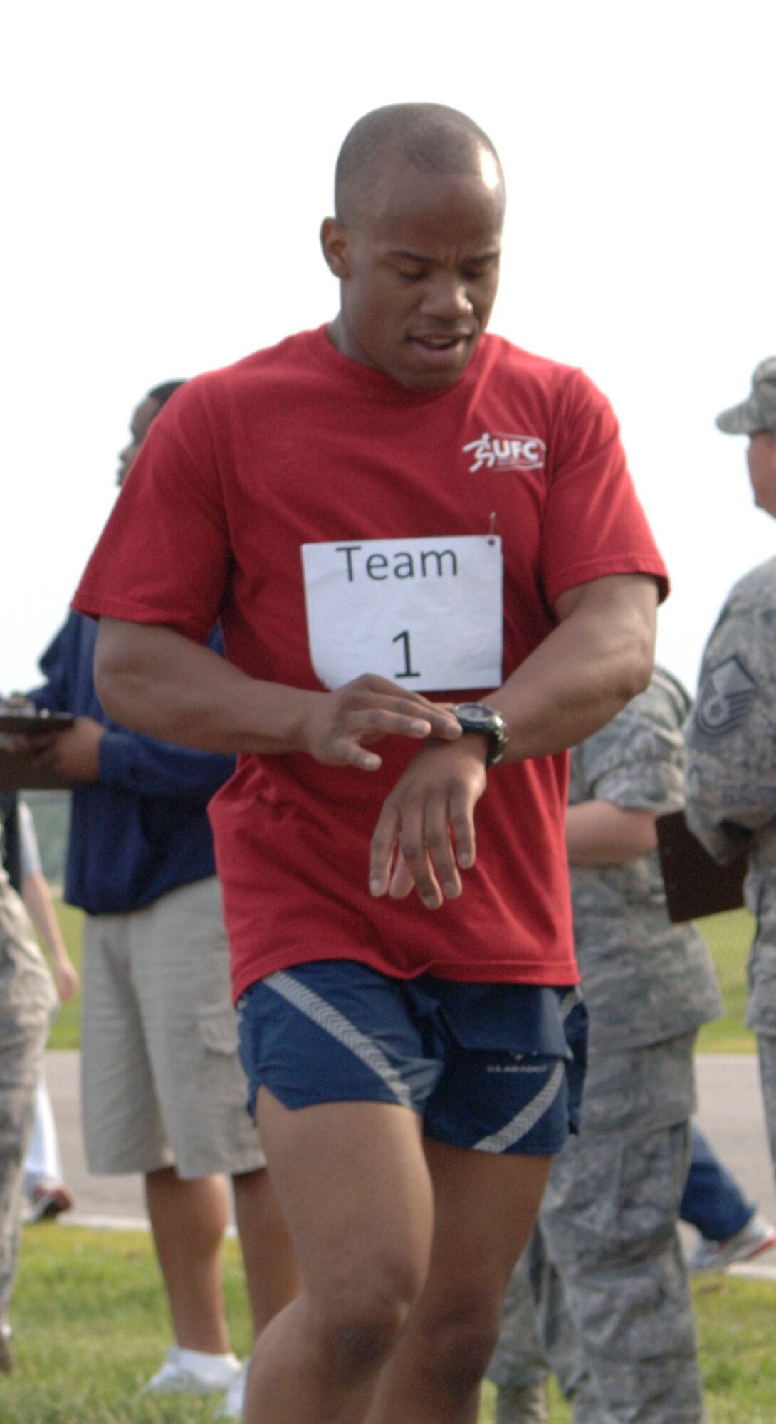 Staff Sgt. Brandon Chism, 375th Civil Engineer Squadron Explosive Ordinance Disposal, crosses the finishline first in the 5K run during the Scott Air Force Base Fitness Challenge 2011. Points were awarded to each team for their best times in a 5K run, a 10K run, a 600 push-ups and sit-ups challenge and a 25 pull-ups challenge. (U.S. Air Force photo/ Airman 1st Class Jacob Eckhardt)

