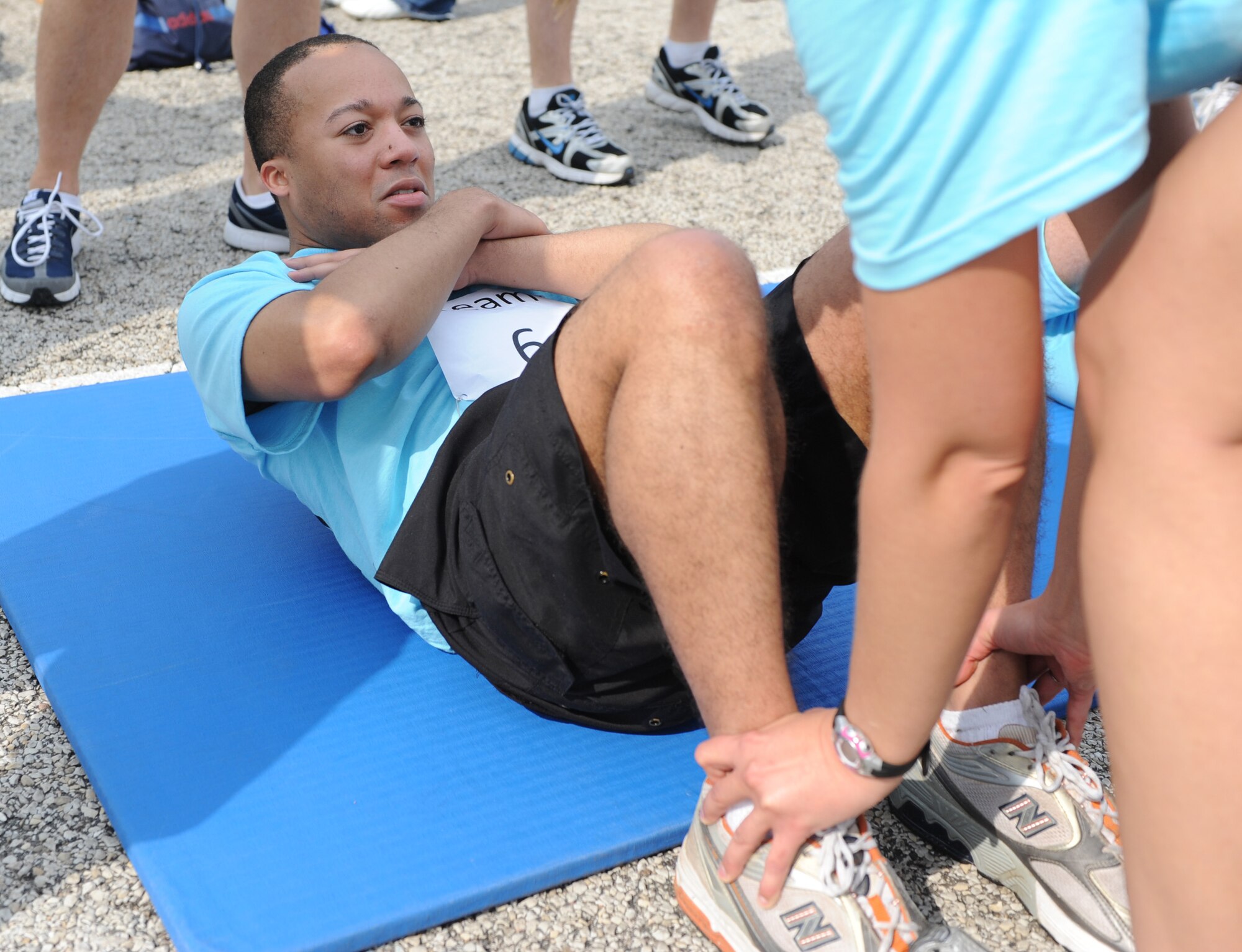Senior Airman Gregory Bean, 375th Air Mobility Wing, does sit-ups during the Scott Air Force Base Fitness Challenge 2011. Each ten member team had to complete 600 sit-ups at their fastest pace. (U.S. Air Force photo/ Airman 1st Class Jacob Eckhardt)