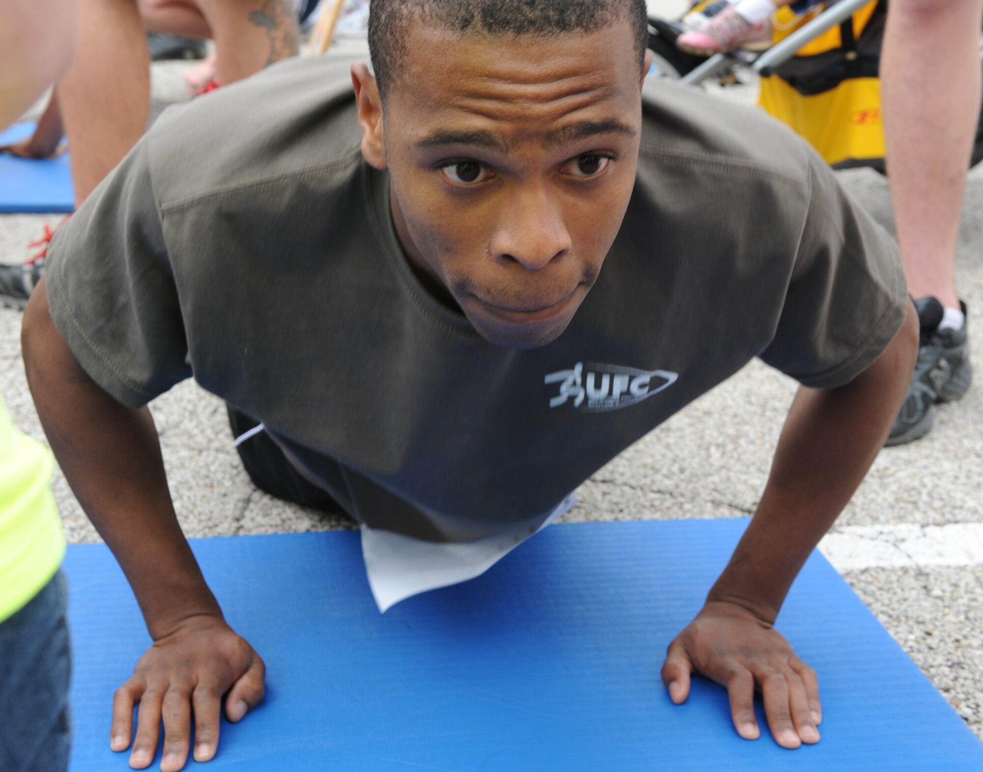 Senior Airman Tyreese Clark, 15th Operational Weather Squadron, does as many push-ups as he can to maximize his team’s points May 20, 2011 at Scott Air Force Base Ill. The event was part of the Scott Air Force Base Fitness Challenge 2011 that also consisted of a 5K run, a 10K run, sit-ups and pull-ups. (U.S. Air Force photo/ Airman 1st Class Jacob Eckhardt)