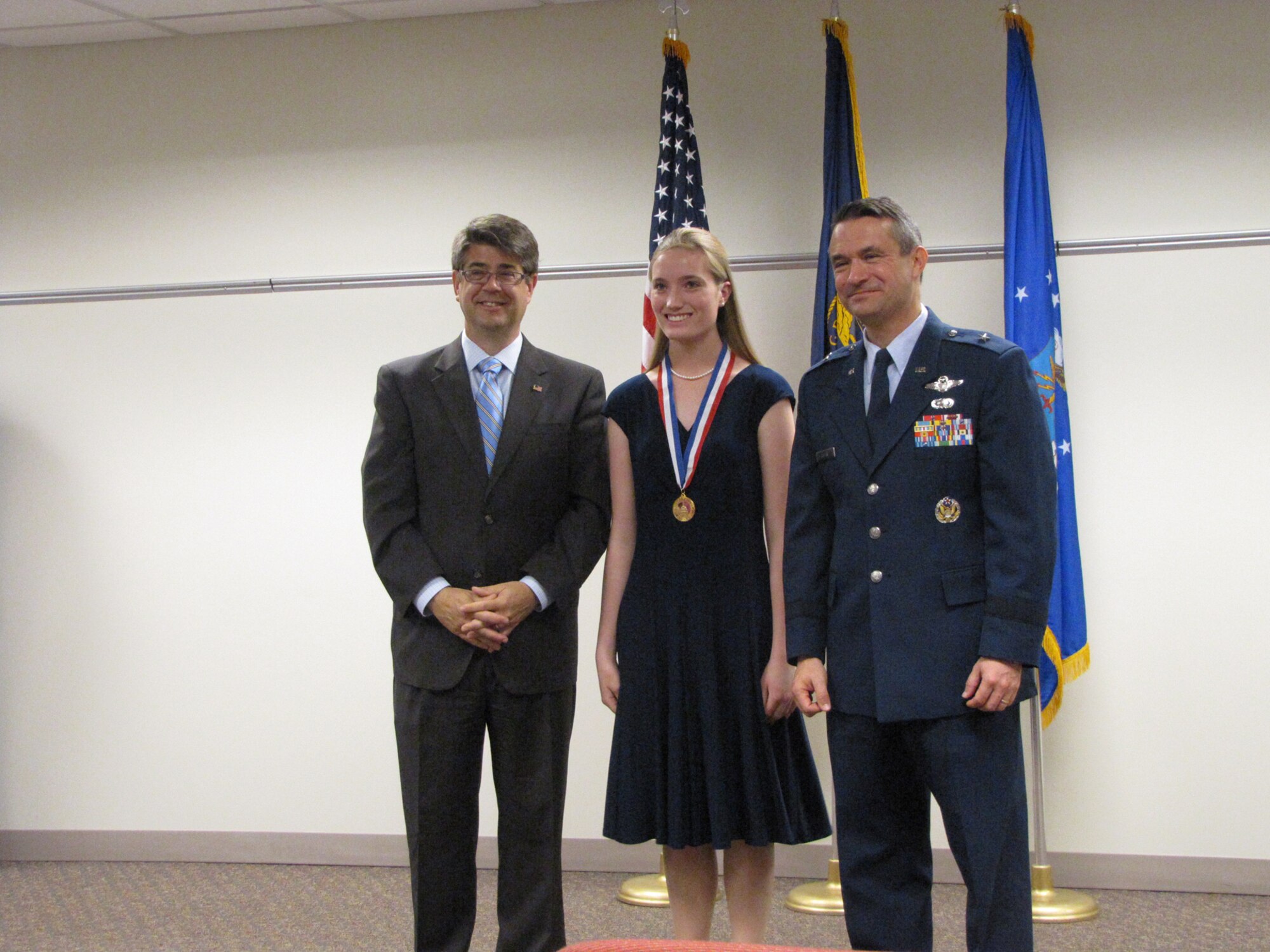 OFFUTT AFB, Neb. – Representative Lee Terry and 55th Wing commander Brig. Gen. Donald J. Bacon presents a congressional gold medal to Ashley Eisert during a ceremony May 17 at the Bellevue Public Schools Welcome Center in Bellevue. Contestants are awarded based on points earned in four areas: volunteer public service, personal development, physical fitness and expedition/exploration activities.