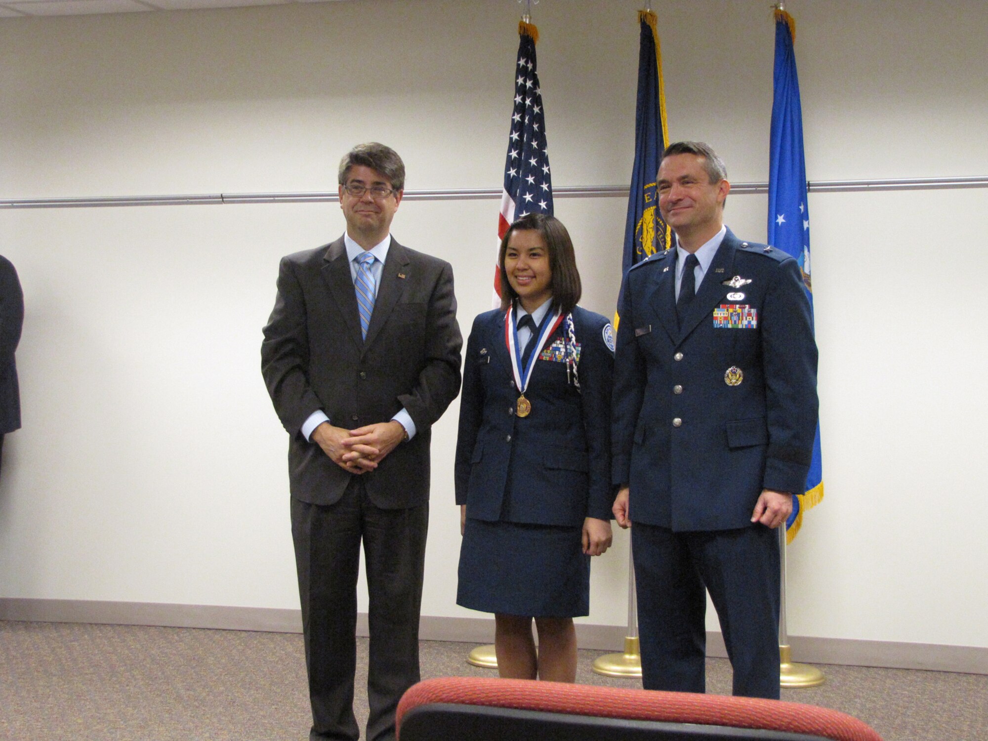 OFFUTT AFB, Neb. – Representative Lee Terry and 55th Wing commander Brig. Gen. Donald J. Bacon presents a congressional gold medal to Sarah Dinogan during a ceremony May 17 at the Bellevue Public Schools Welcome Center in Bellevue. Contestants are awarded based on points earned in four areas: volunteer public service, personal development, physical fitness and expedition/exploration activities.