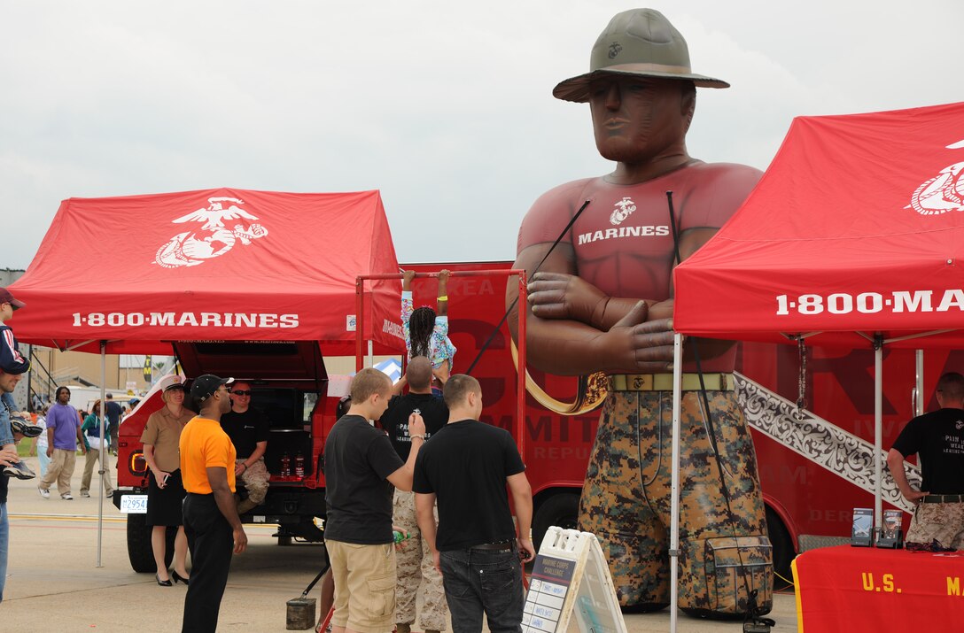 The Marine Corps Recruiting Command pull-up bar poses a challenge for the crowd at the 2011 Joint Service Open House at Joint Base Andrews, Md.  JSOH affords the public an excellent opportunity to meet and interact with the men and women of the Armed Forces and to showcase military equipment from the Navy, Marines, Army, Air Force, and Coast Guard.  JSOH is planned and conducted by Total Force; Active, Guard, Reserve, Civilian employees, as well as retirees and family. (U.S. Marine Corps photo)