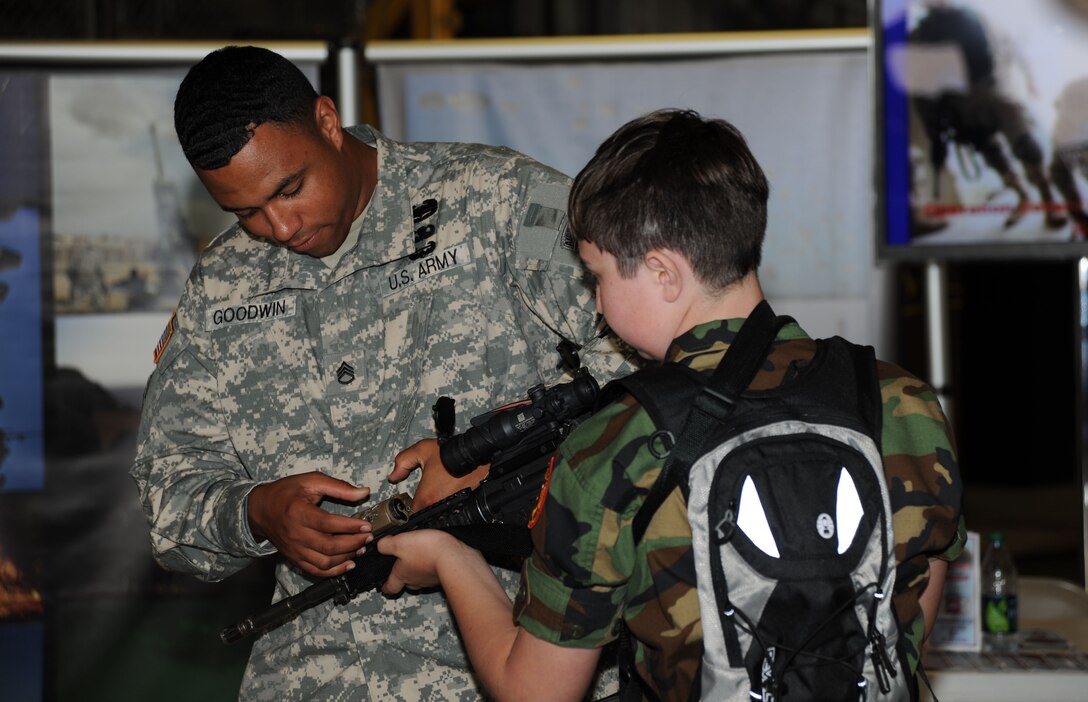 Army Staff Sgt. Garrick Goodwin with the 82nd Airborne Division from Fort Bragg, NC instructs Jonathan Ciavolino of the Maryland Civil Air Patrol on proper handling of the M-4 at the 2011 Joint Service Open House, here May 20th .  JSOH affords the public an excellent opportunity to meet and interact with the men and women of the Armed Forces and to showcase military equipment from the Navy, Marines, Army, Air Force, and Coast Guard.  JSOH is planned and conducted by Total Force; Active, Guard, Reserve, Civilian employees, as well as retirees and family. (U.S. Marine Corps photo)