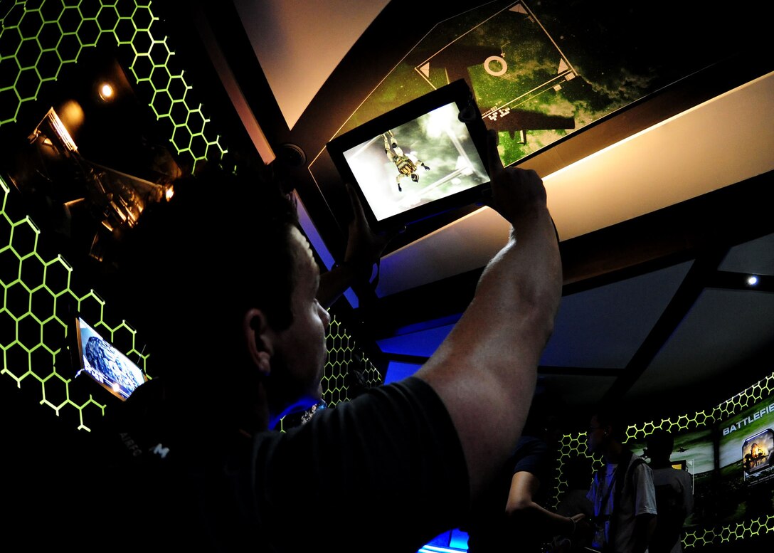 Guests attending the 2011 Joint Service Open House view Command Center Alpha inside the Air Force recruitment tent here May 20. Command Center Alpha is a high tech, augmented reality experience used to highlight the capabilities of the Air Force. JSOH affords the public an opportunity to meet the men and women of the Armed Forces and see military equipment from the Navy, Marines, Army, Air Force, and Coast Guard. JSOH is planned and conducted through the efforts of active duty, guard and reserve service members, as well as civilian employees, retirees and family members. (U.S. Air Force photo/Staff Sgt. Nichelle Anderson)