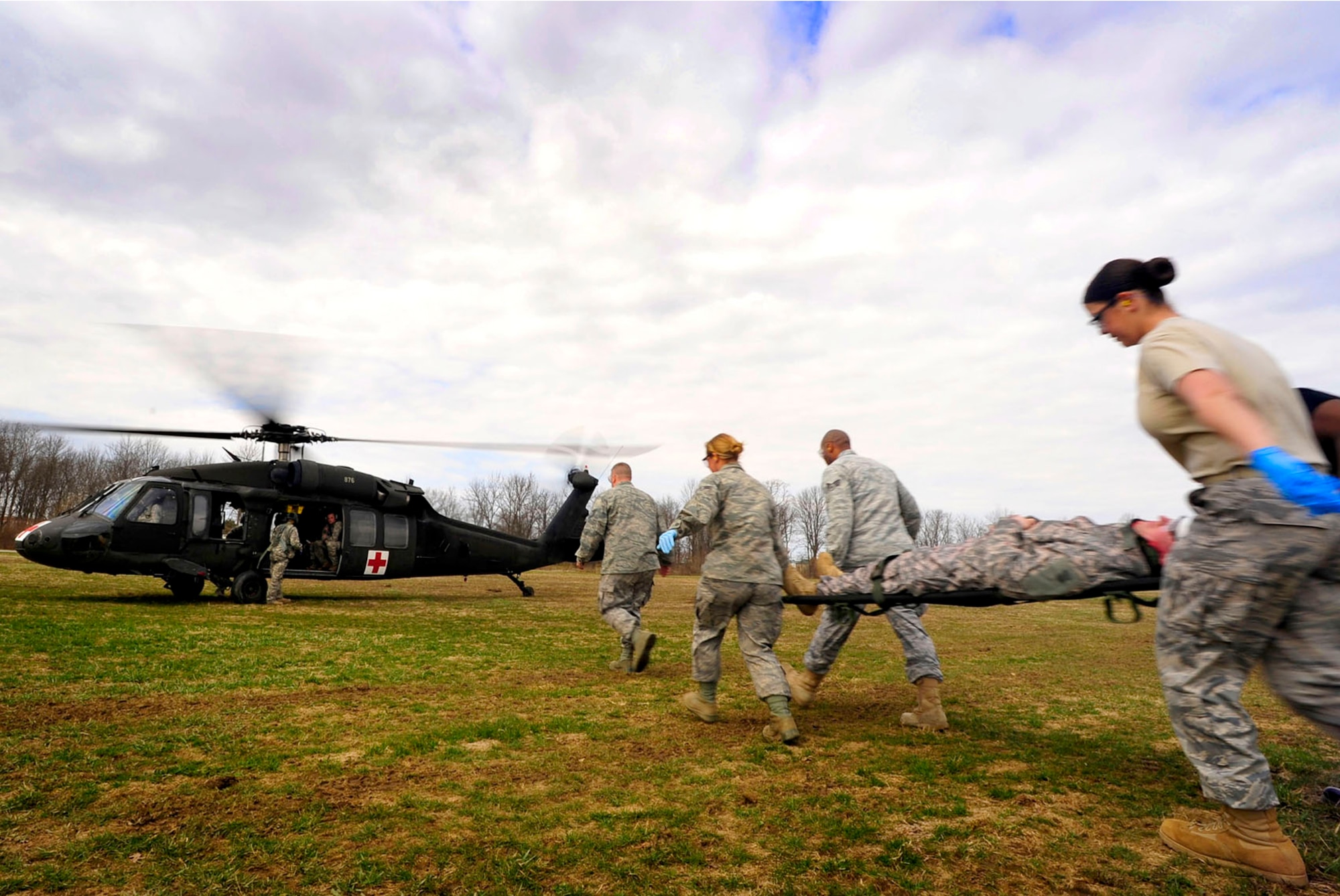 Airmen with the 99th Medical Group, stationed at Nellis Air Force Base, Nev., carry a ?patient? to a UH-60 Black Hawk March 17, 2011, during Exercise Vibrant Response at Camp Atterbury, Ind. Defense Secretary Robert Gates recently promised more forward-deployed medical capabilities for service members in Afghanistan. 
