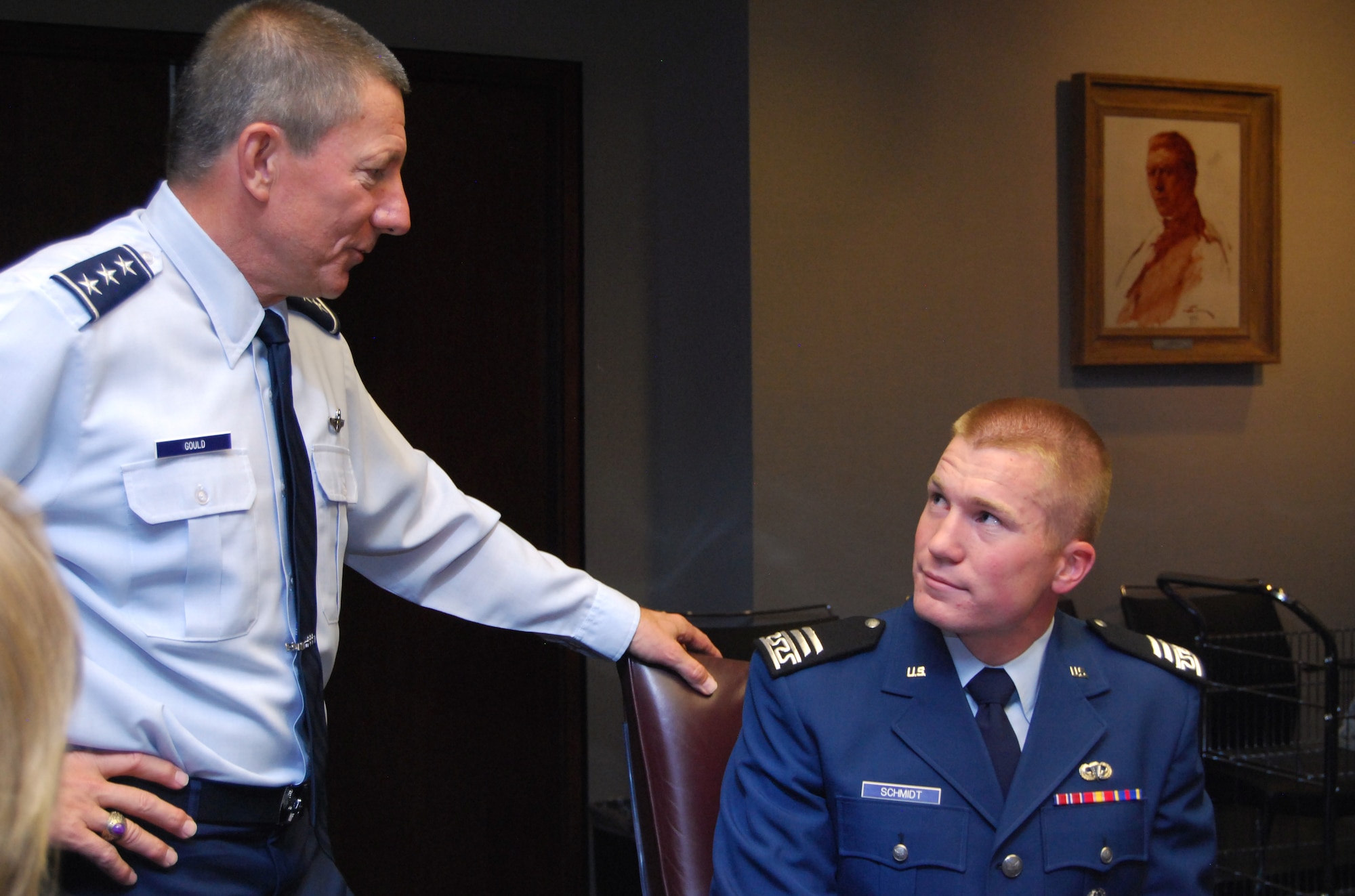 Lt. Gen. Mike Gould surrenders his seat to Cadet 1st Class Hal Schmidt during a meeting of the Air Force Academy Board at the Academy May 20, 2011. Cadet Schmidt, a native of Cody, Wyo., assigned to Cadet Squadron 22, was named the top graduate for the Academy Class of 2011 by the board based on his academic, military and physical fitness scores. General Gould is the Academy superintendent. (U.S. Air Force photo/Don Branum)