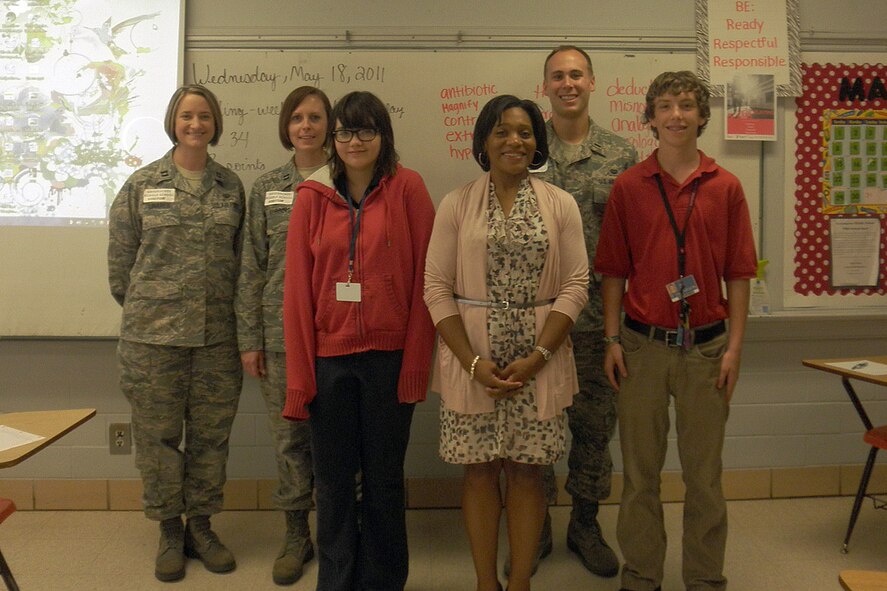 Members of the 2nd Bomb Wing Legal office present an award and coin to each of Mrs. Felicia Gunn's students who won the essay contest for the 2011 Law Day at Green Acres Middle School in Bossier City, La., May 18. From left to right, pictured are Capt. Amanda L.K. Linares, Capt. Jessica L. Robbins, Sierra Trent, winner for the morning class, Mrs. Felicia Gunn, 1st Lt. William J. Diggs and Zack Alber, winner for the afternoon class. (courtesy photo by Thienduc Doan, a student at Green Acres Middle School)